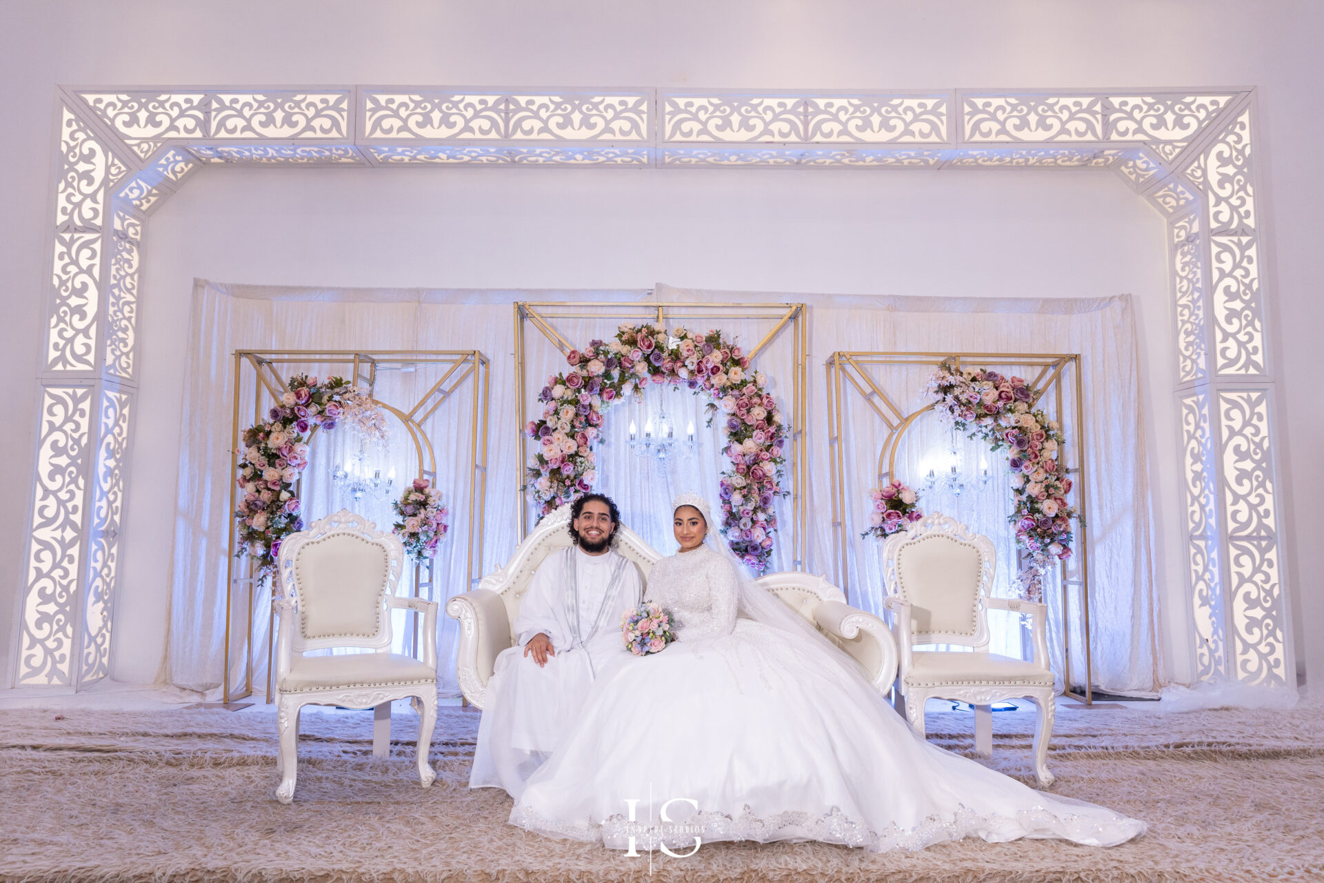 Bride and groom on the stage at Pavilion Banqueting Walthamstow, London – captured by Inspire Studios
