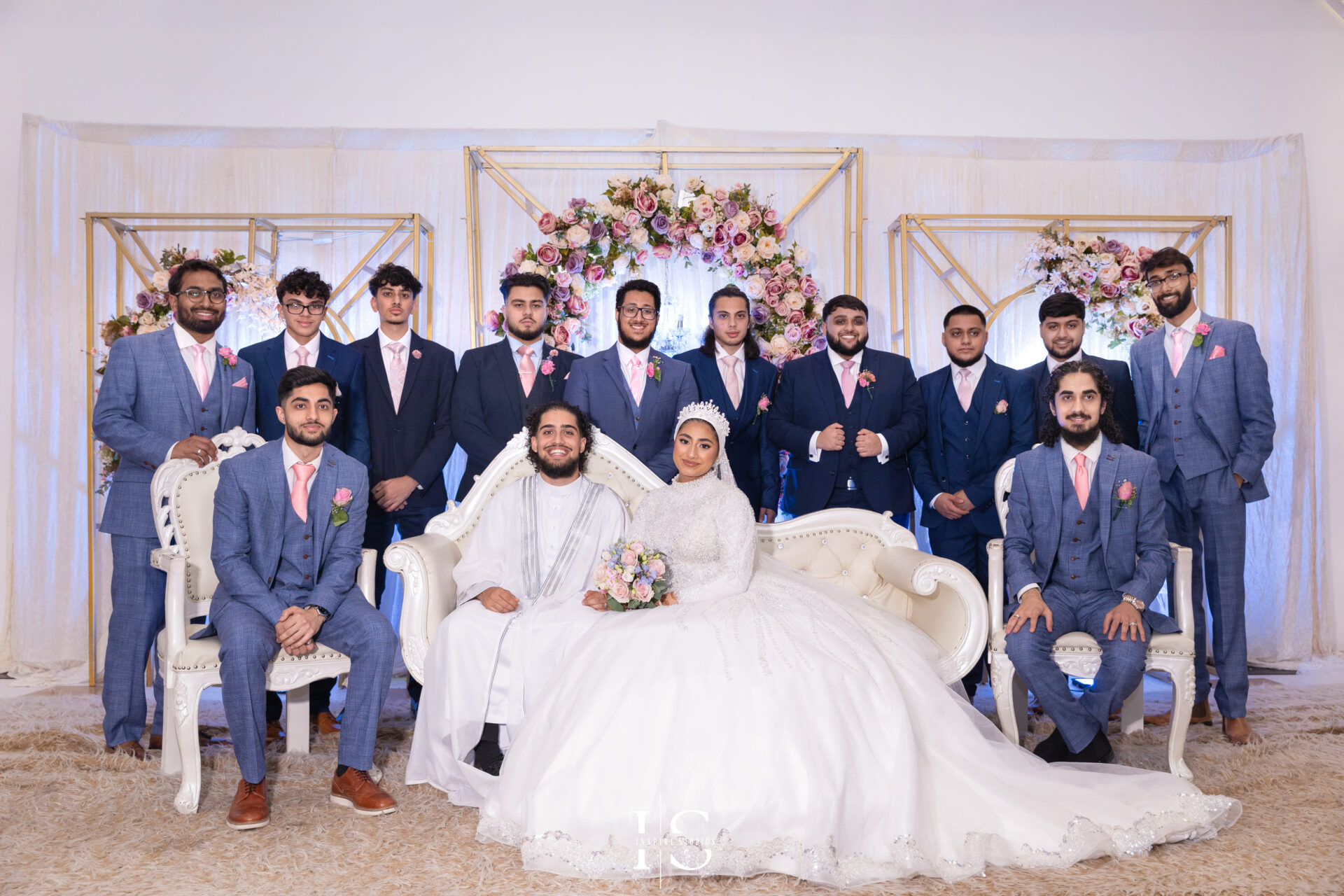 Bride, groom, and friends on the stage at Pavilion Banqueting Walthamstow, London – captured by Inspire Studios