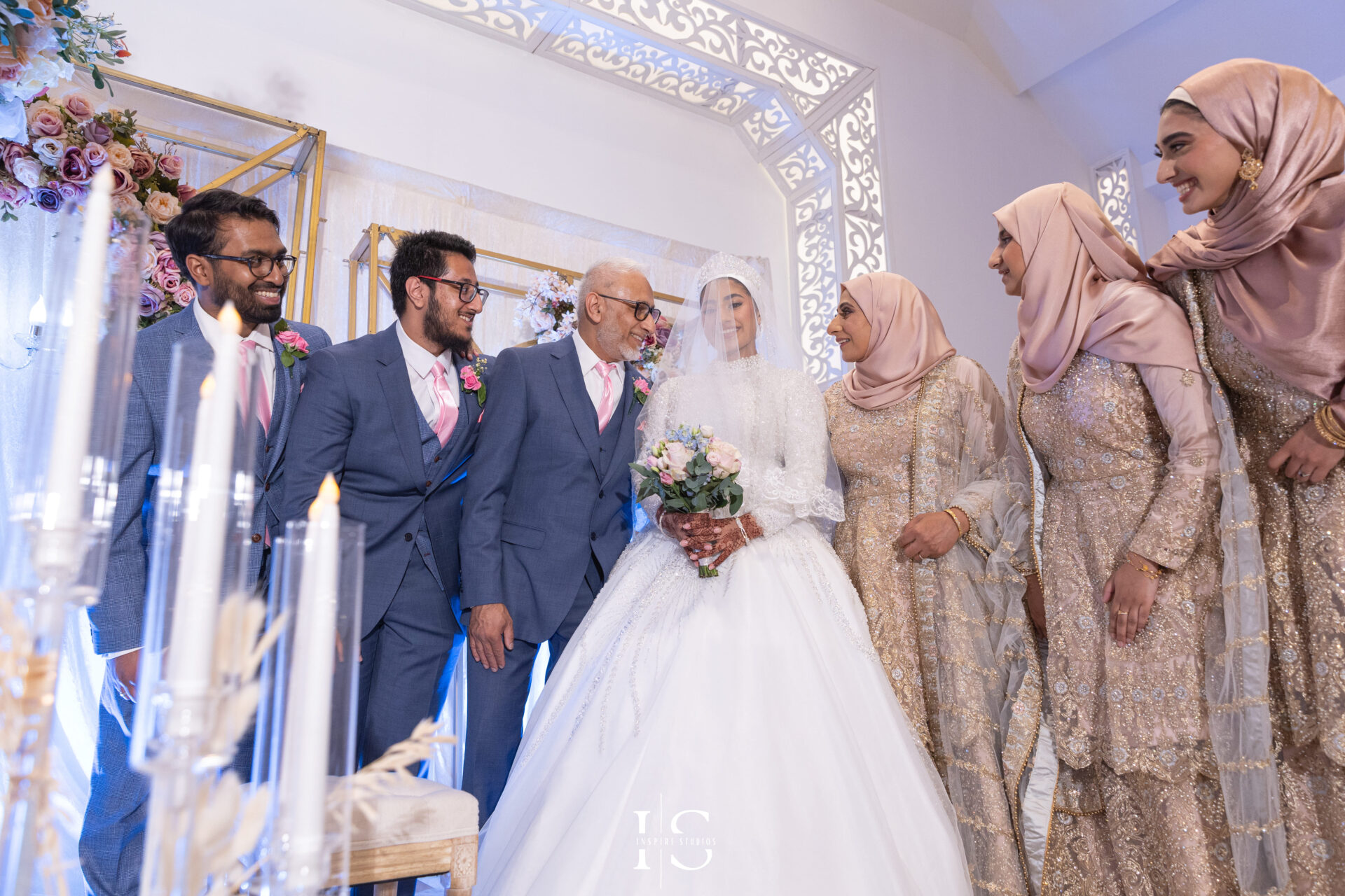 Bride and her family candid photo on stage at Pavilion Banqueting Walthamstow, London – captured by Inspire Studios