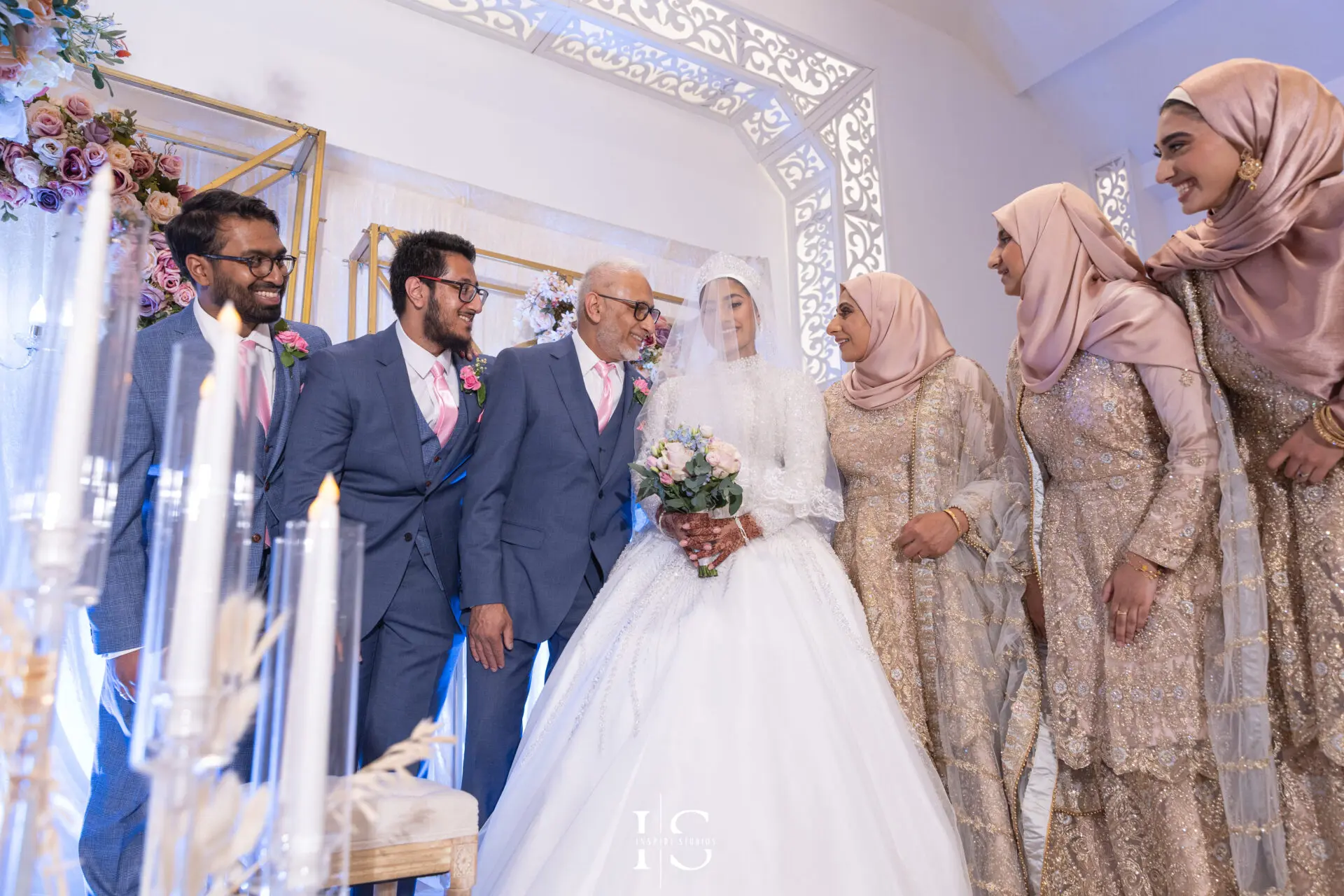 Bride and her family candid photo on stage at Pavilion Banqueting Walthamstow, London – captured by Inspire Studios