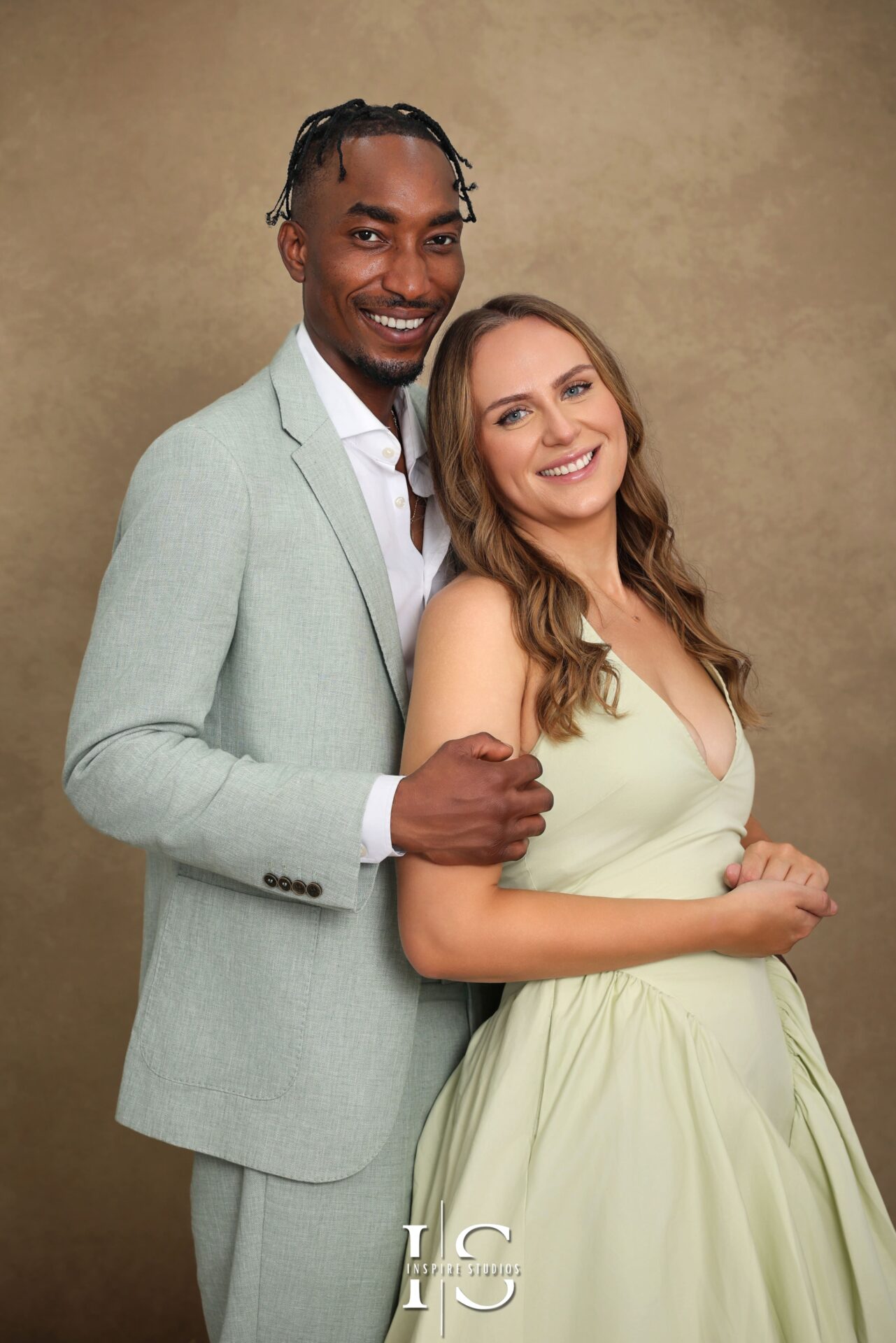 Couple and family enjoying a professional studio photoshoot in London with warm, elegant lighting