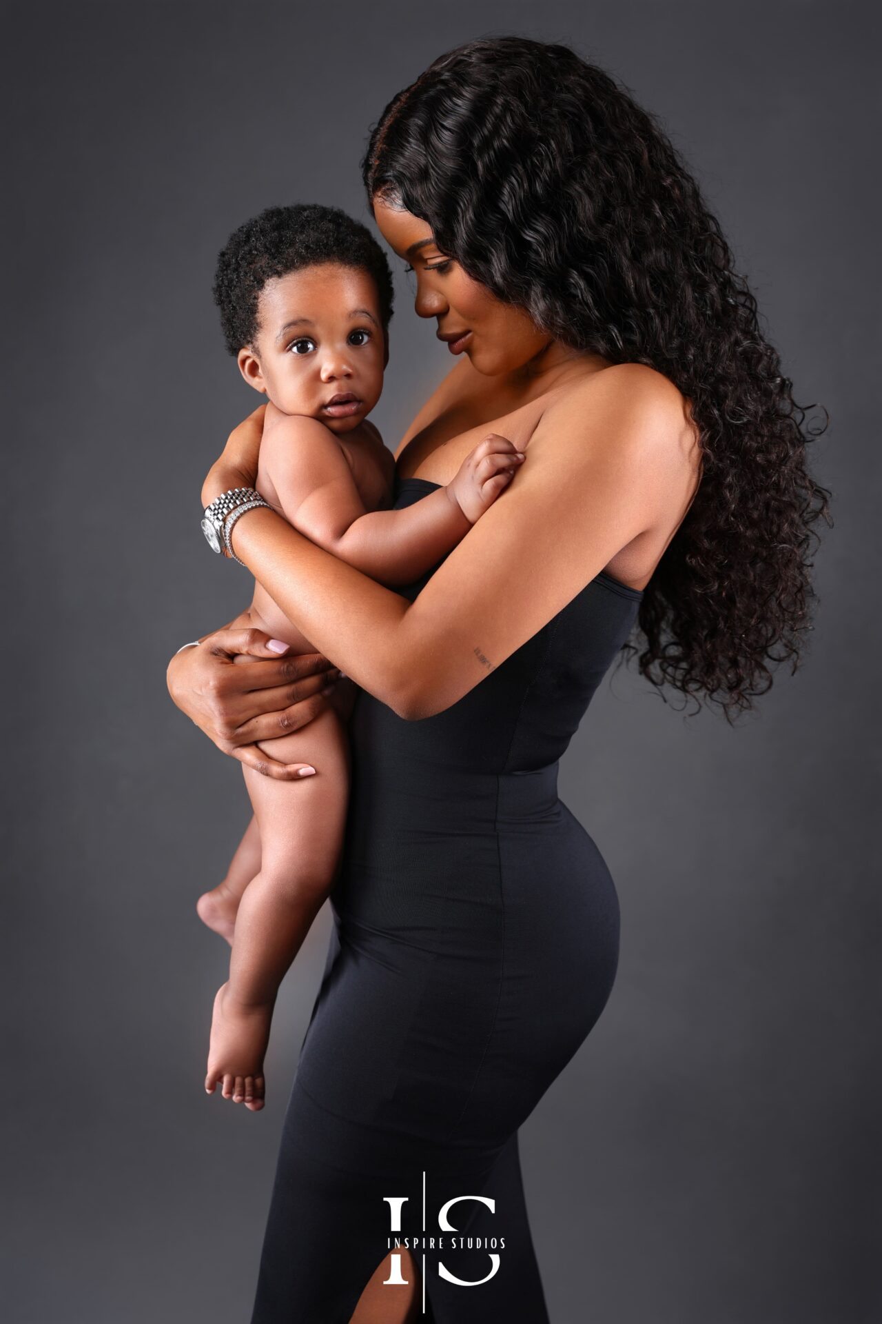 Fine art photography portrait of a mother and her son with soft lighting and artistic composition