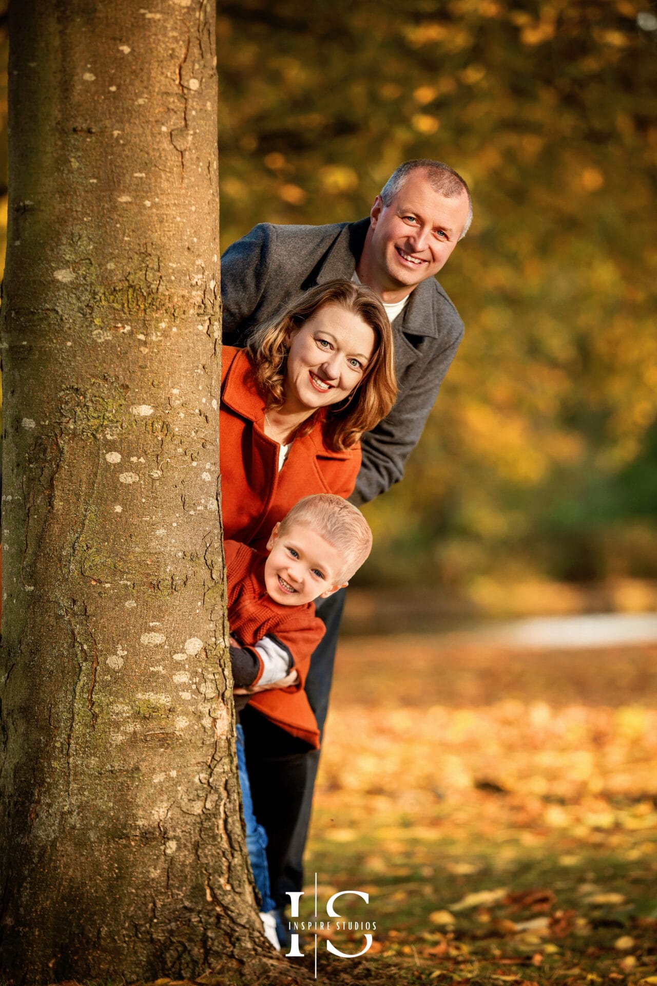 Outdoor family portraits in London during autumn, photographed with colourful seasonal foliage.