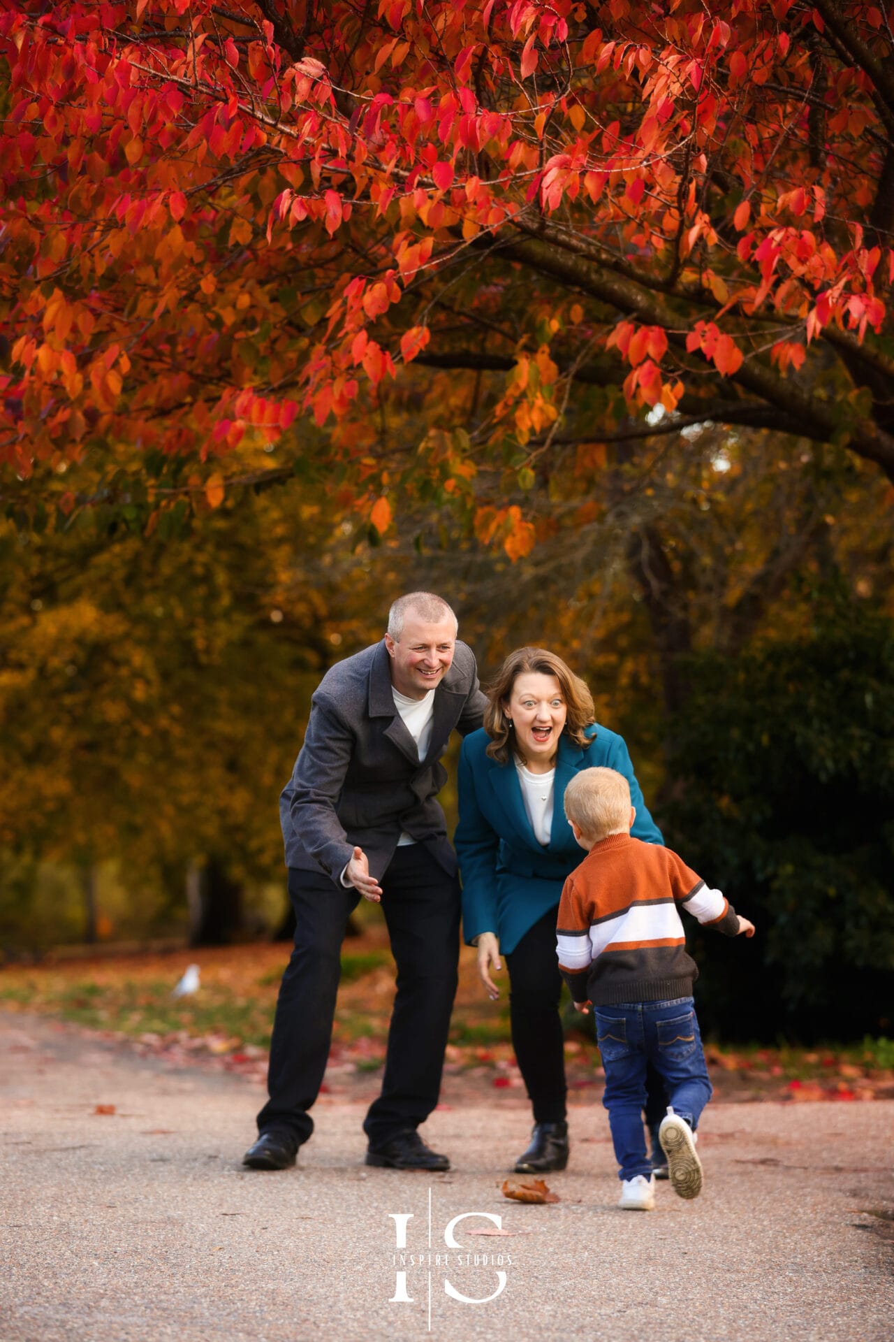 Autumn outdoor family photoshoot in Valentines Park with seasonal foliage and warm natural lighting.