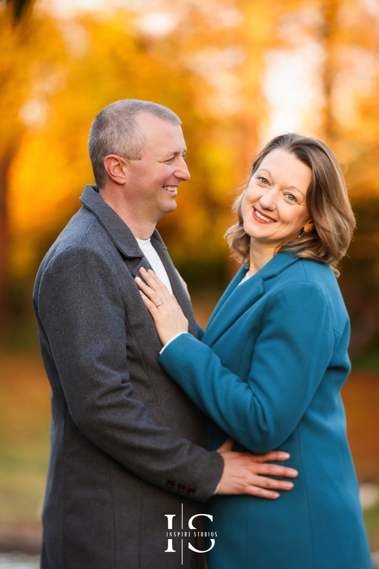 Parents photoshoot in Valentines Park during autumn, photographed among colourful fallen leaves.