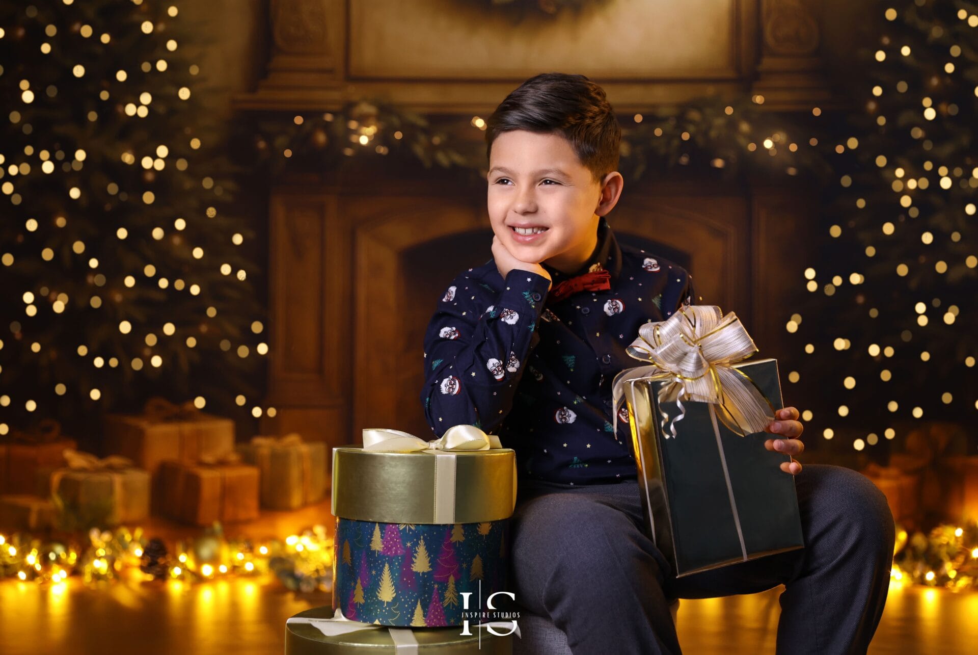 Christmas holiday portrait of a mother and her son smiling together in a festive studio setting