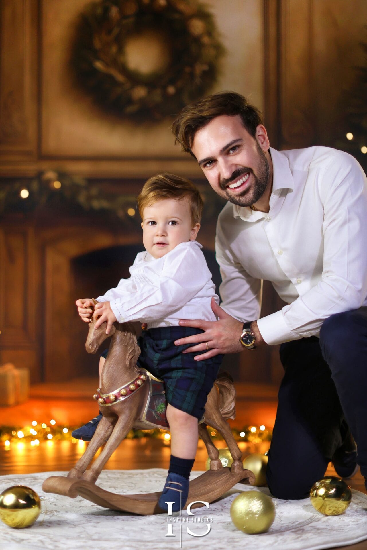 Italian father and son Christmas portrait in London – professional family photography capturing festive holiday moments and natural smiles.