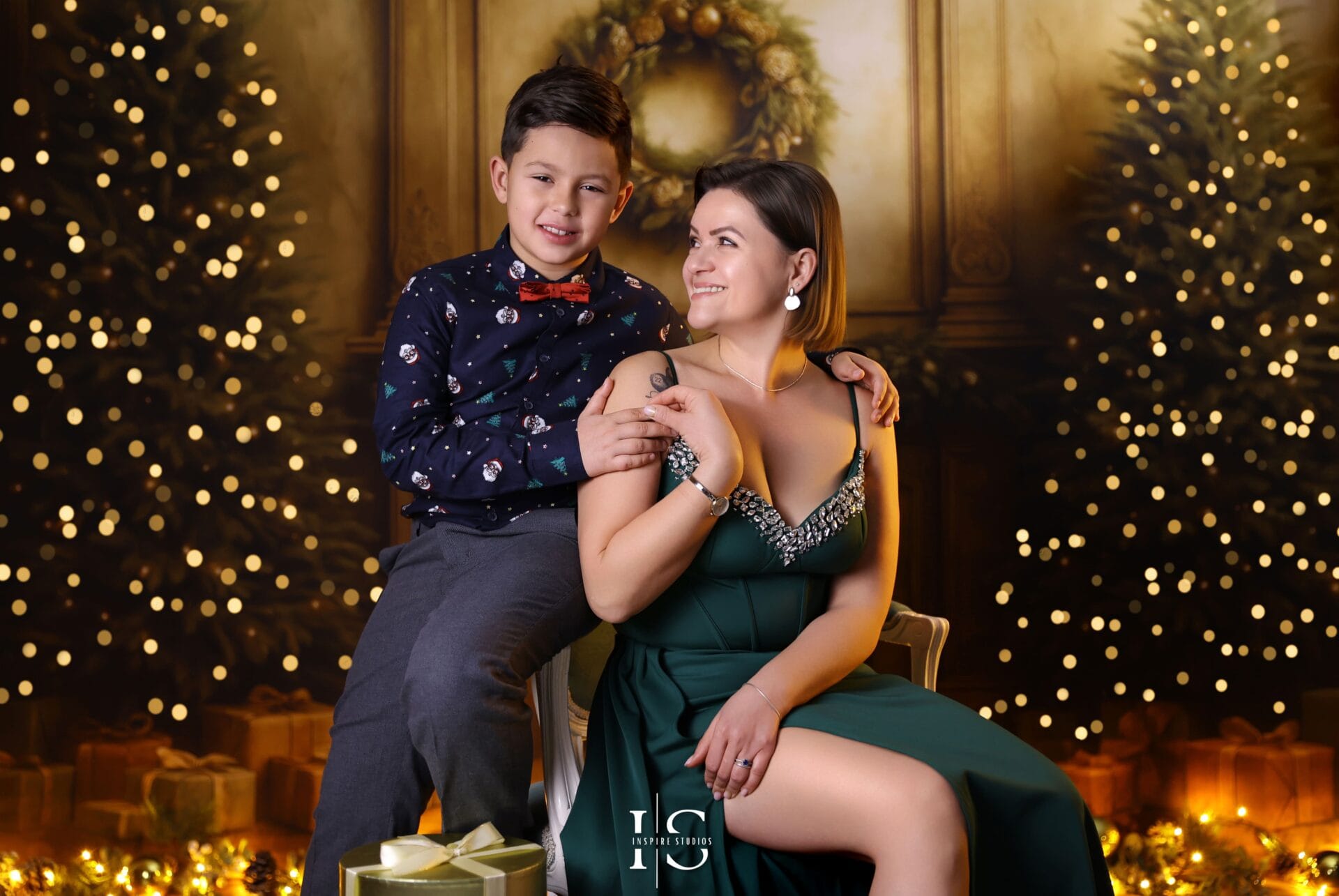 Mother and son Christmas photoshoot with festive family holiday theme and warm seasonal lighting.
