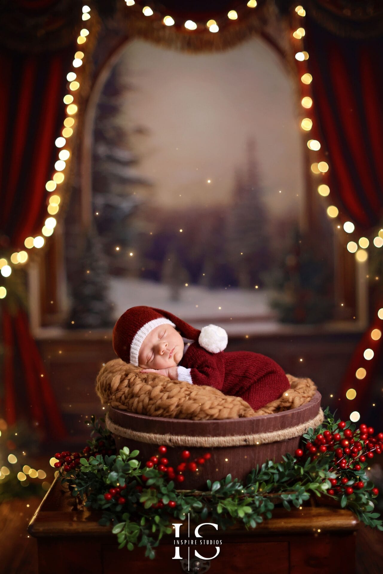 Newborn Christmas photoshoot in London studio with festive decorations, professional newborn posing and holiday baby styling.