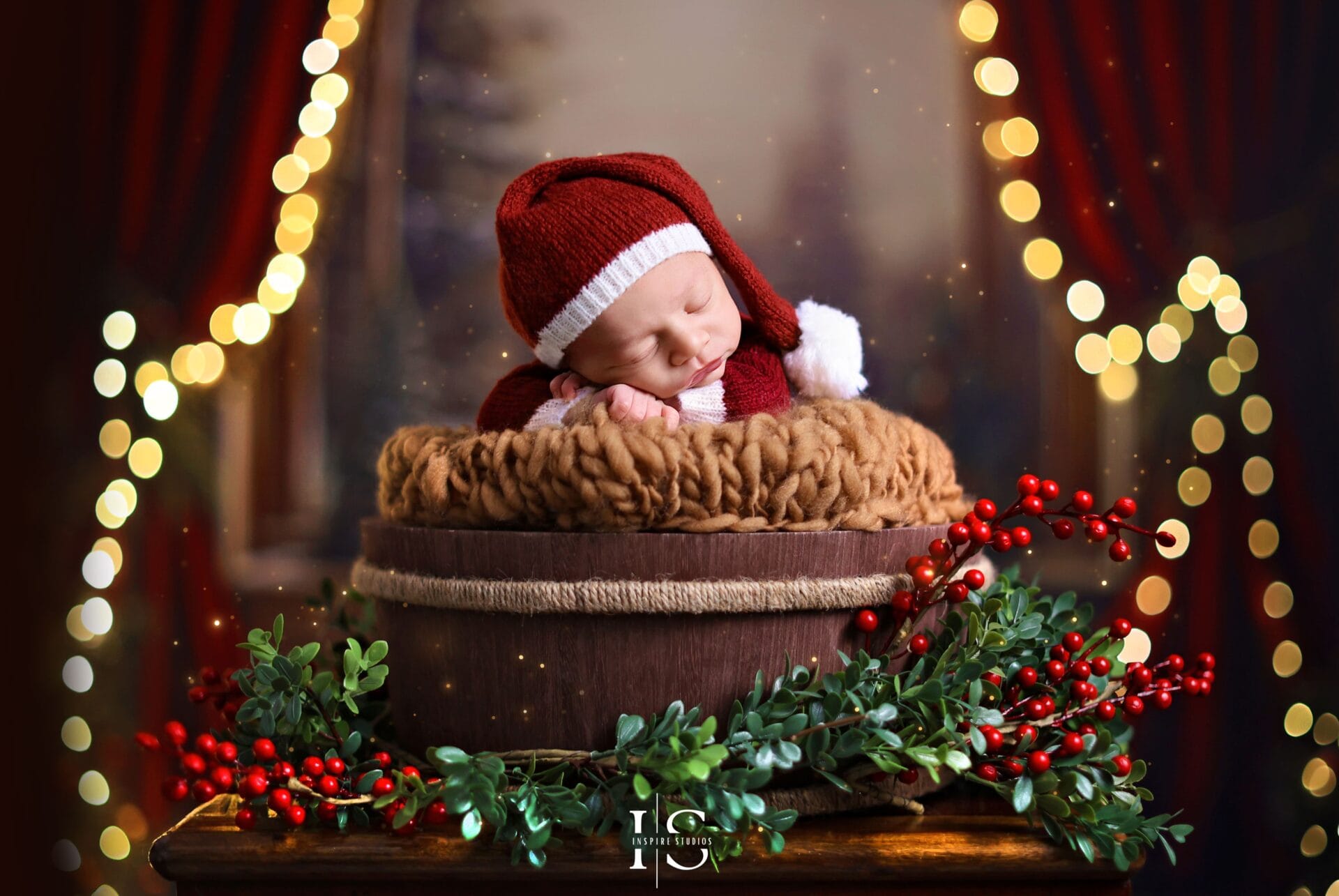 Newborn Christmas studio photoshoot in London with holiday décor, newborn-safe posing, and soft festive lighting.