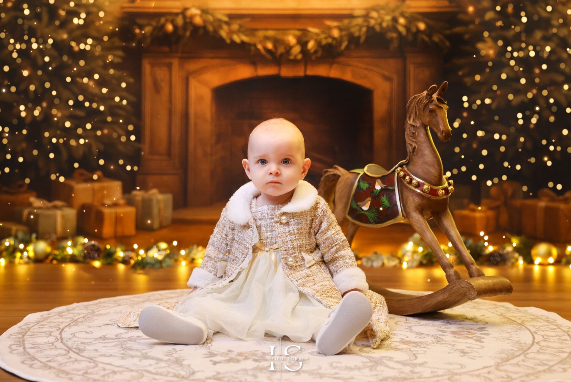 Baby’s first Christmas portraits with soft lighting and elegant holiday styling
