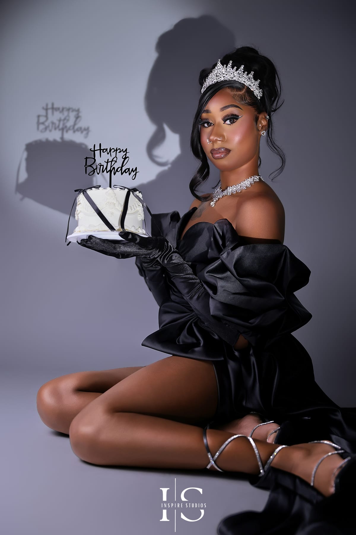 Luxury spotlight birthday photoshoot for women in London with elegant styling and dramatic lighting.