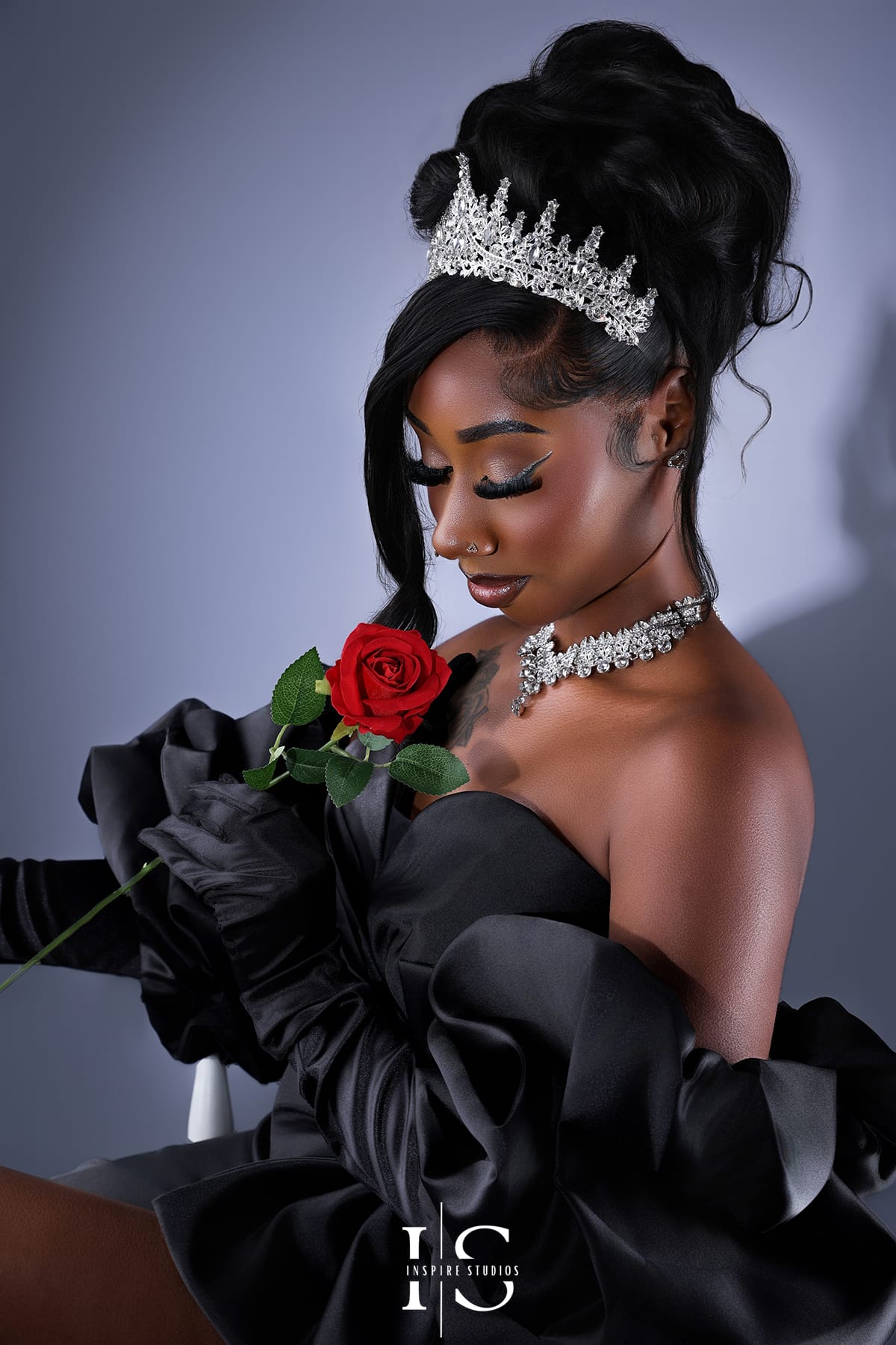 Studio spotlight birthday photoshoot in London UK with dramatic lighting and a clean black background.