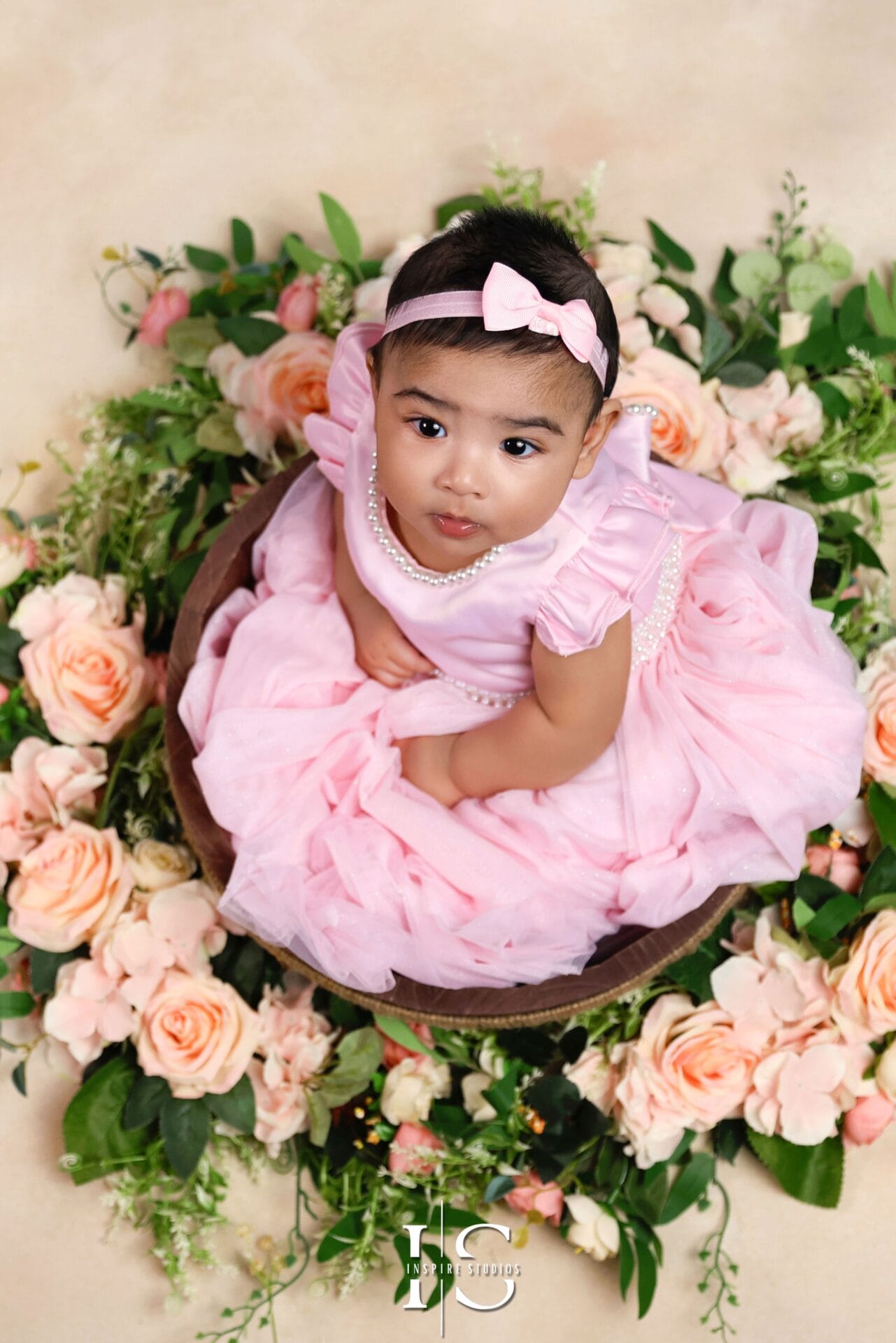 Toddler girl wearing a pink pearl-embellished tulle party dress with matching bow headband, suitable for 1 to 2 years old, perfect for birthdays and photoshoots.