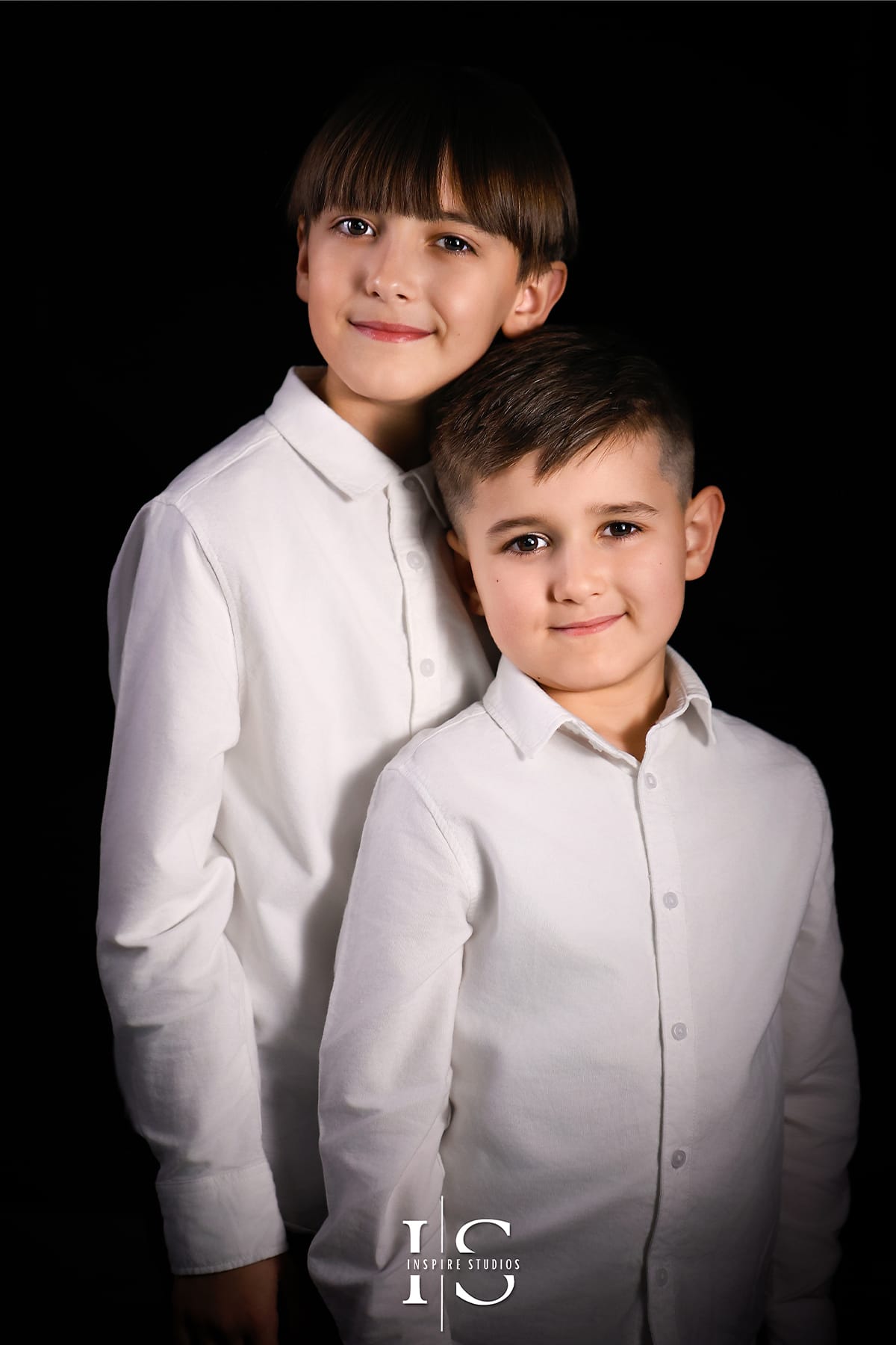 Children fine art studio portrait photographed at Inspire Studios London, featuring a timeless child portrait with professional studio lighting and a classic dark background.