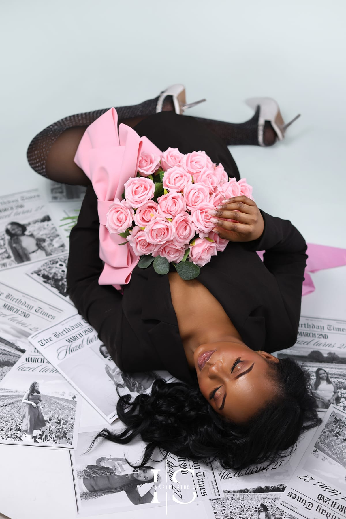 Editorial style newspaper theme photoshoot with dramatic lighting and fashion-inspired posing.