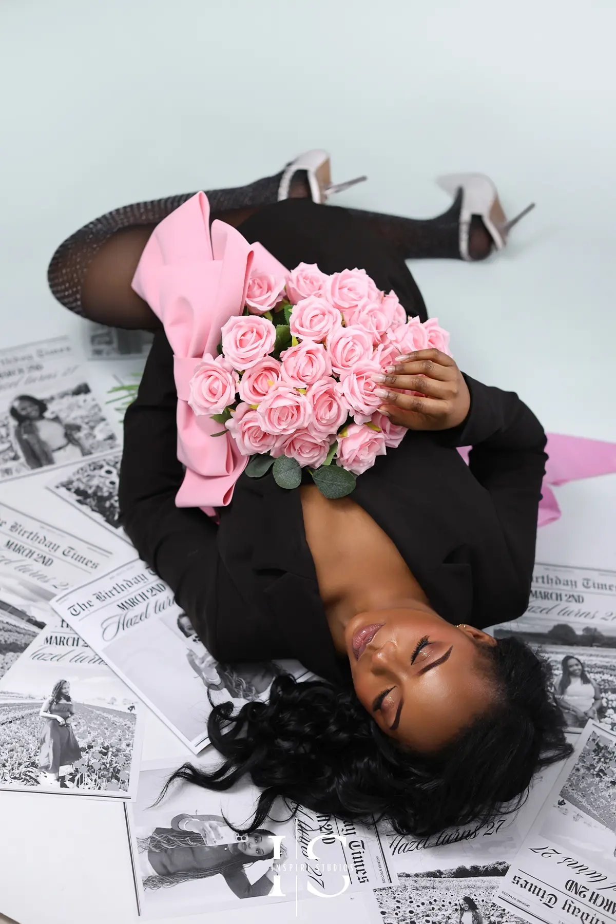 Editorial style newspaper theme photoshoot with dramatic lighting and fashion-inspired posing.