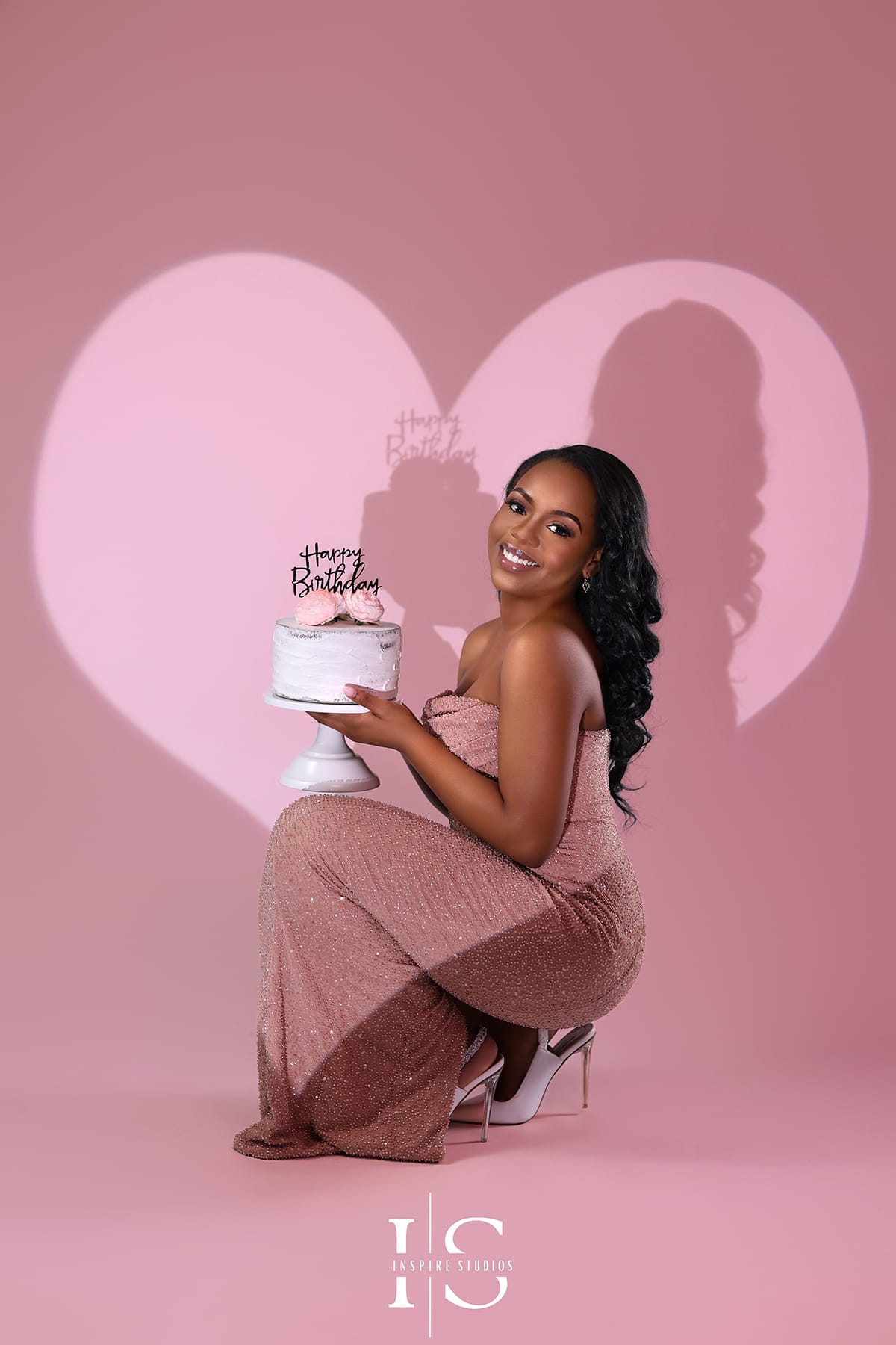 Pink backdrop birthday photoshoot in London studio with luxury styling and professional photography.