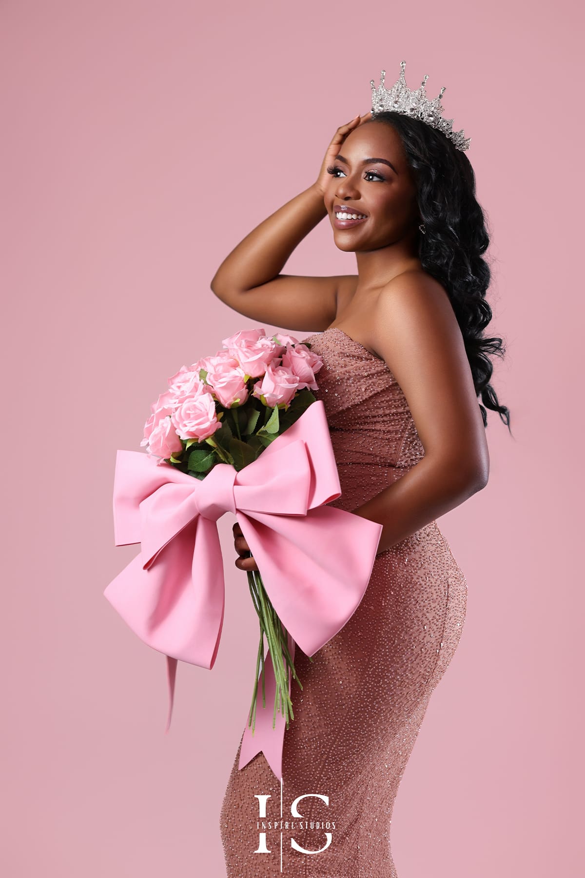 Elegant pink backdrop birthday photoshoot with soft studio lighting and stylish birthday pose.