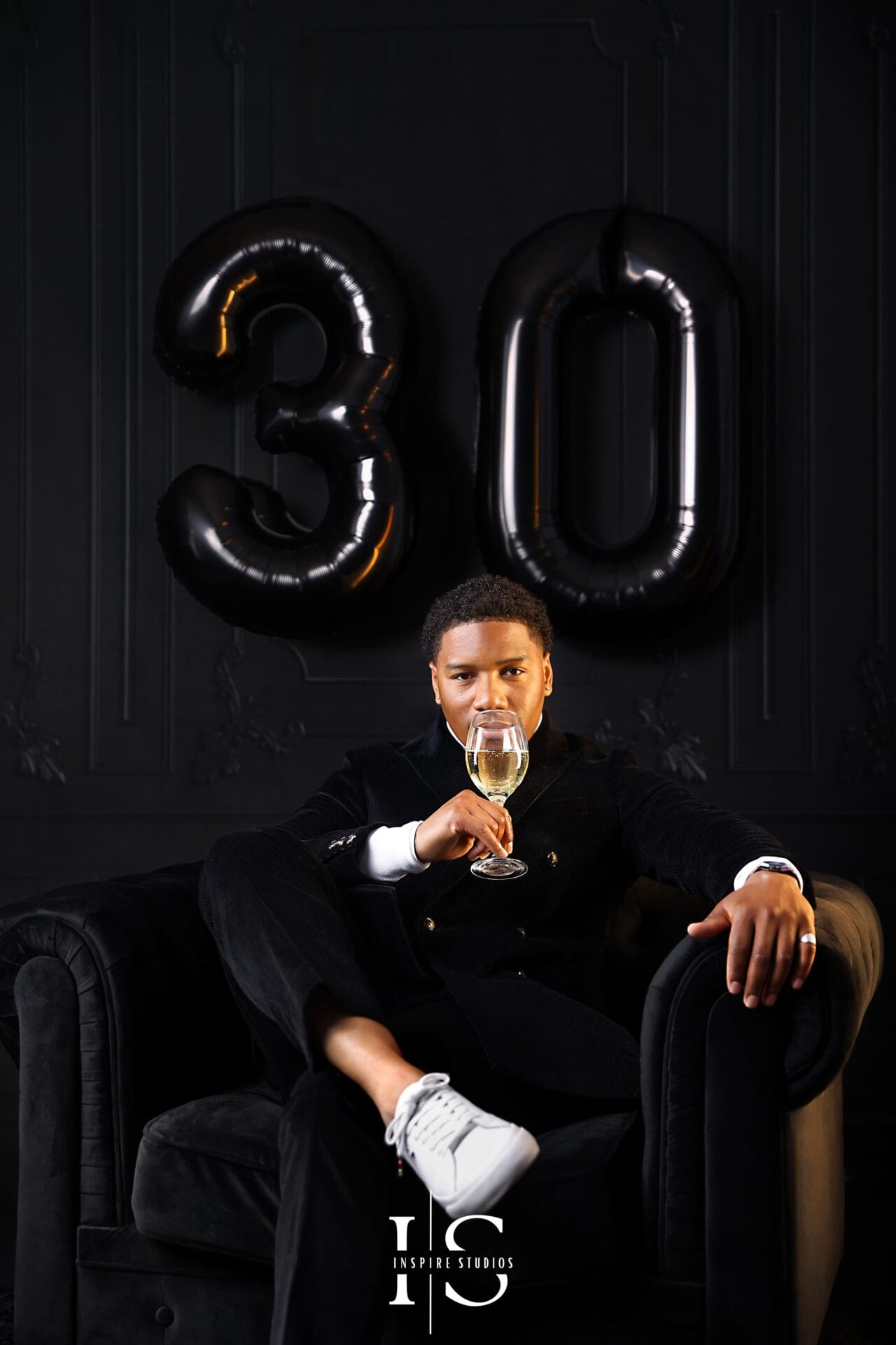 elegant mens 30th birthday portrait holding champagne glass studio photo