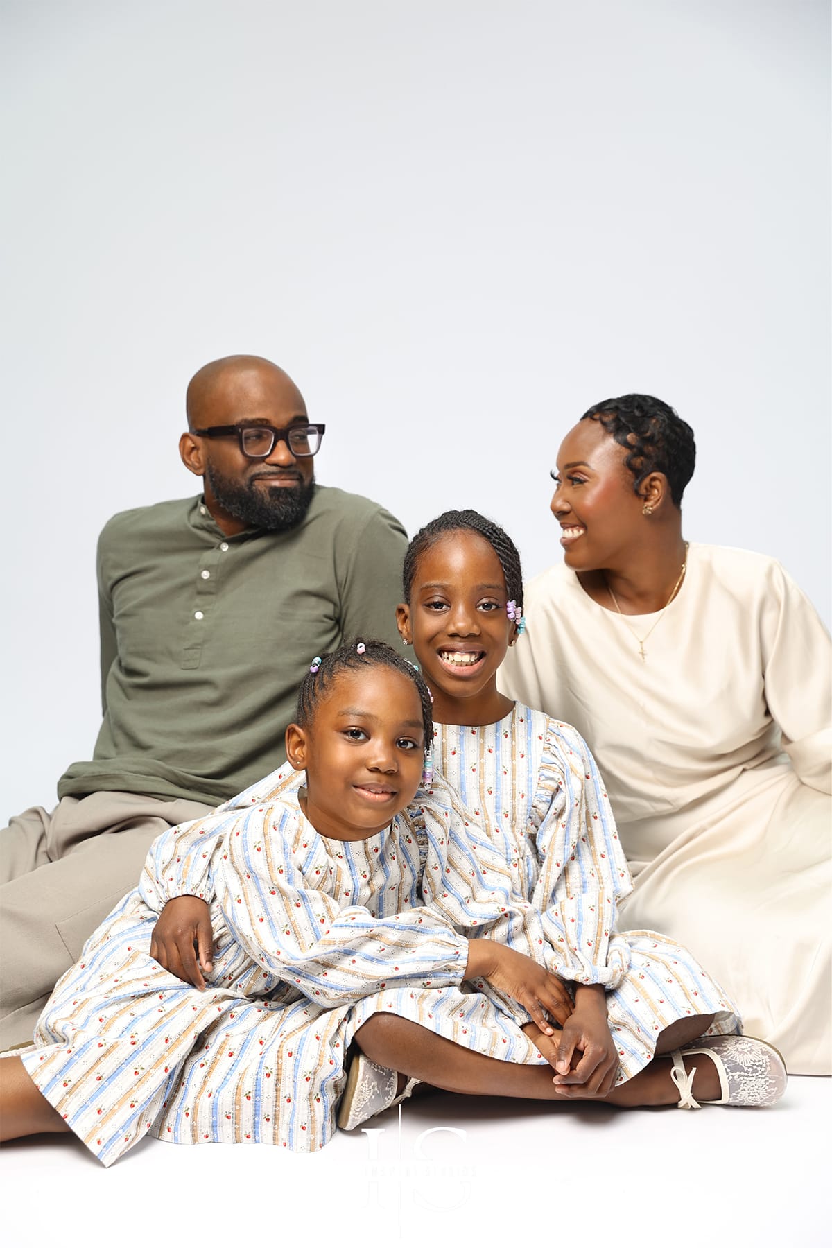 family studio photoshoot with relaxed posing and natural expressions in professional setting