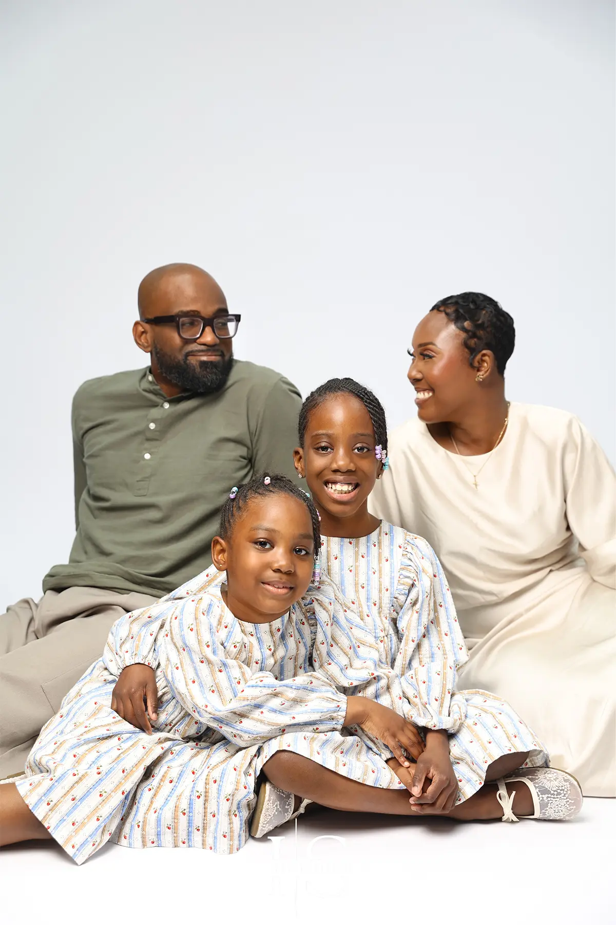 family studio photoshoot with relaxed posing and natural expressions in professional setting