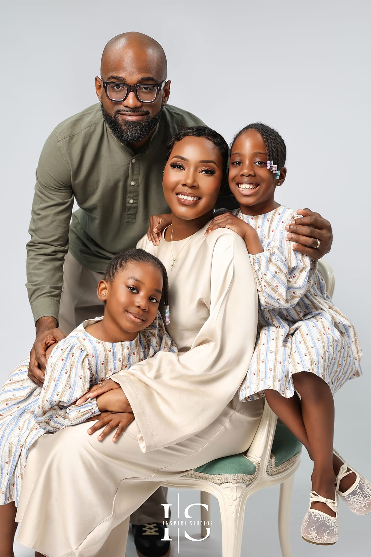 family studio photoshoot portrait with modern lighting and natural family interaction