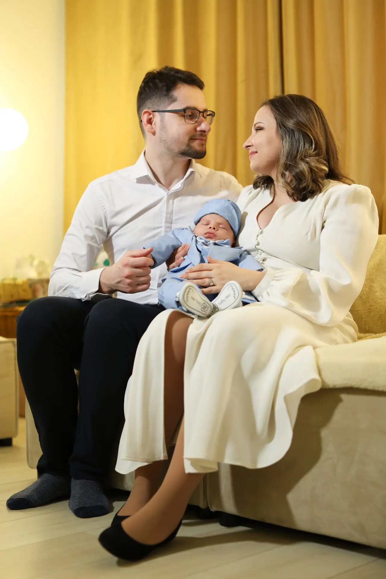 Christening photographer capturing natural family moments with parents, godparents and baby