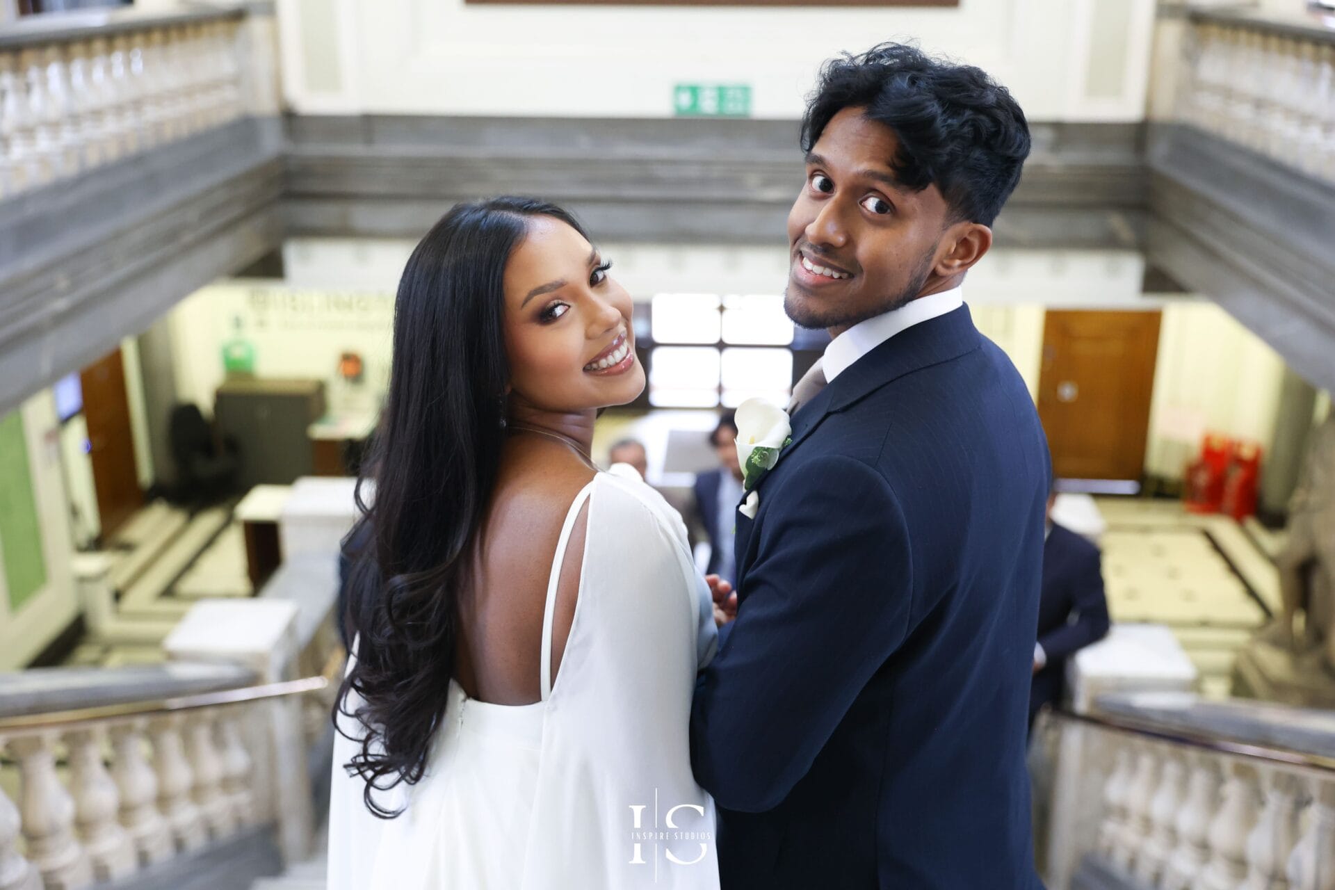 Wedding day at Islington Town Hall London with couple celebrating outside venue