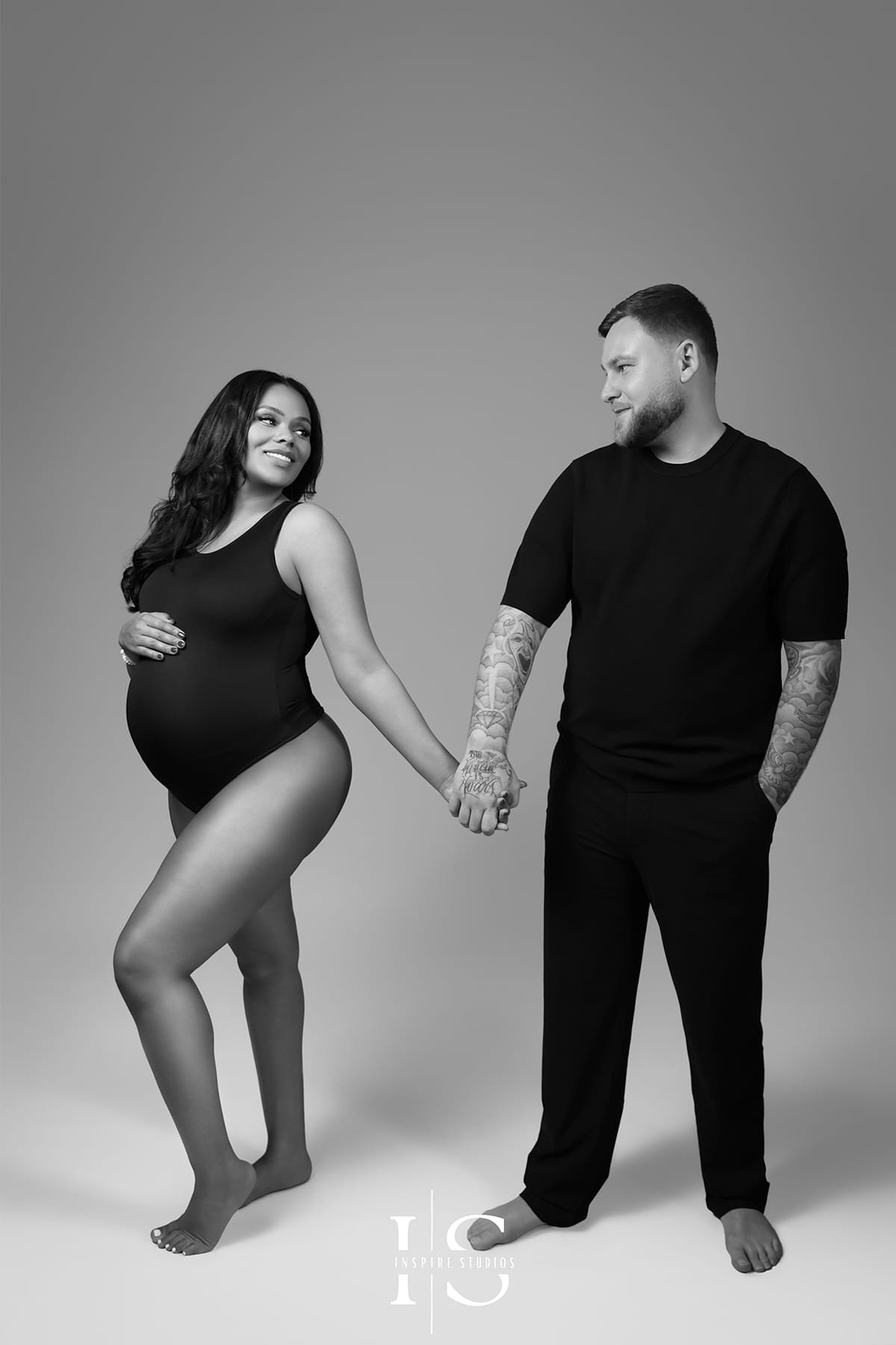 Black and white maternity photographer in London capturing elegant pregnancy couple portraits.