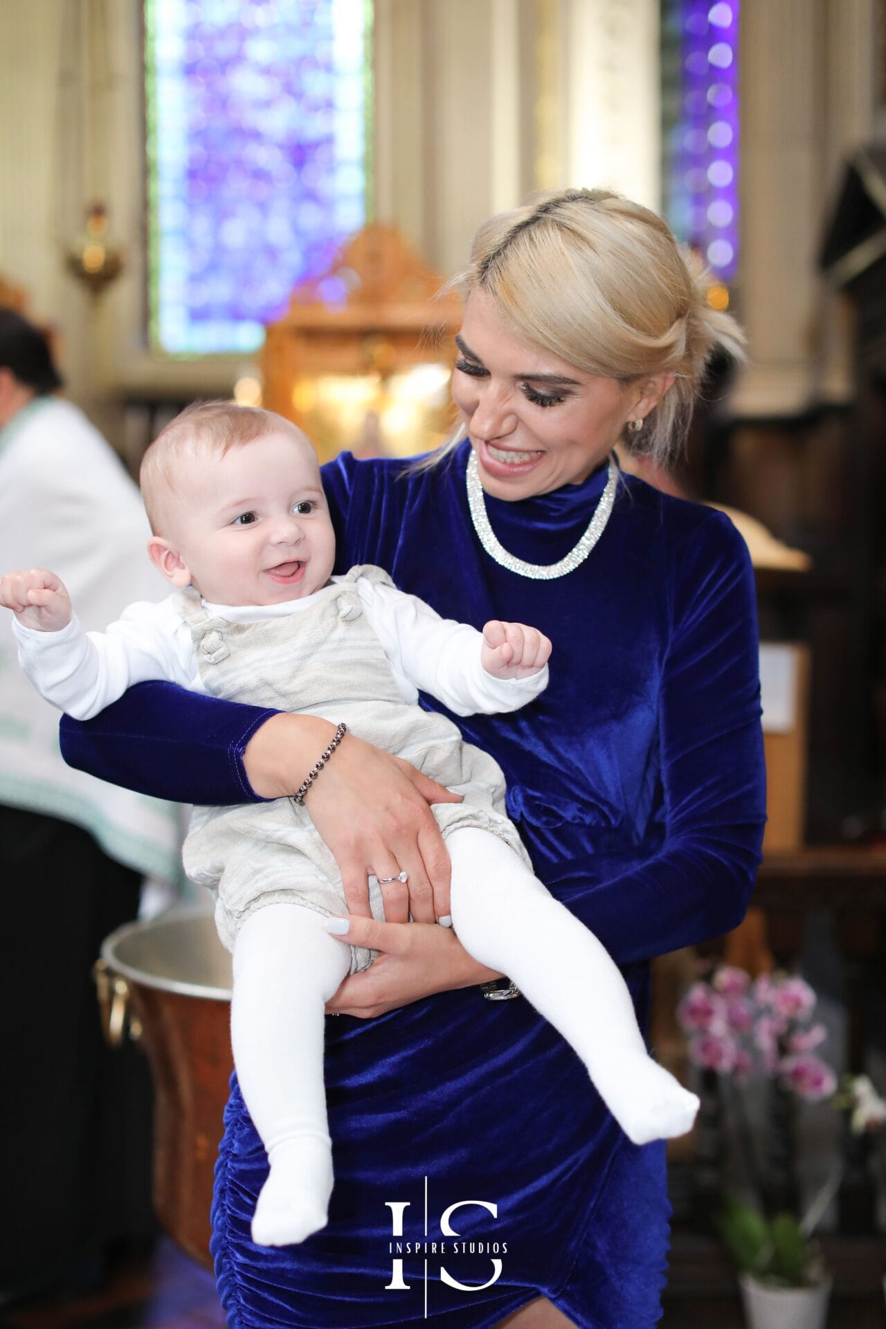 Candid christening service moments in a London church, capturing natural family emotions during the ceremony.