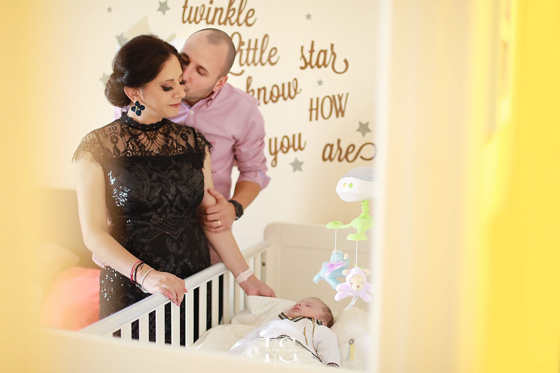 Family moments before christening captured at home in London with baby and parents.