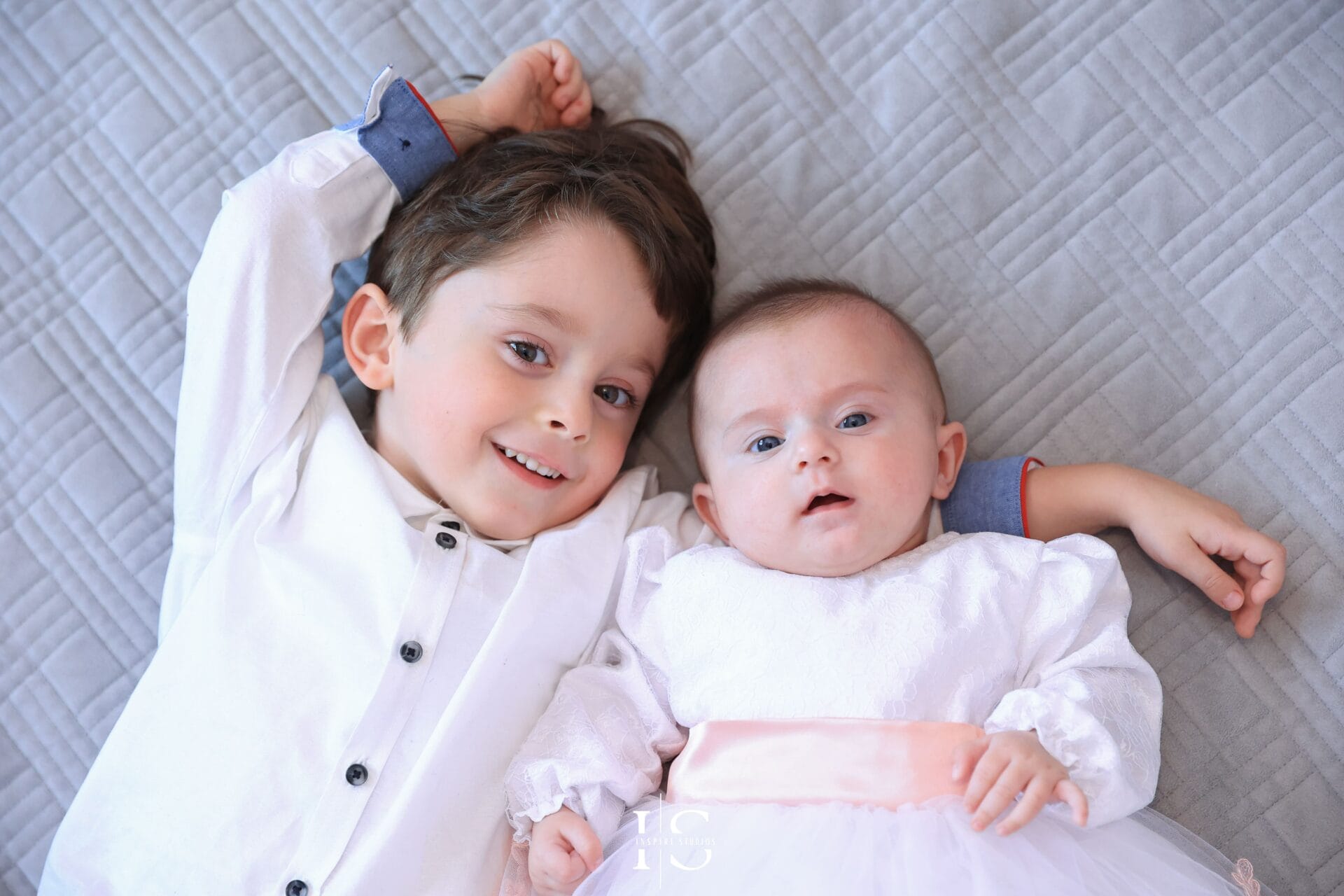 Parents and baby christening photos in London, capturing natural family moments before the church ceremony.