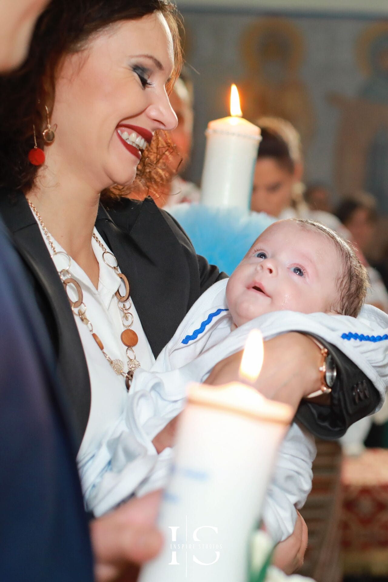 Romanian female christening photographer in London at Parohia Sf. Ilie, capturing baby and family moments.