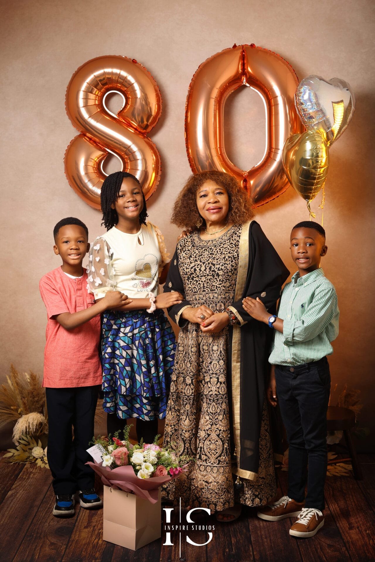 80th birthday photos with grandchildren in a London studio photoshoot