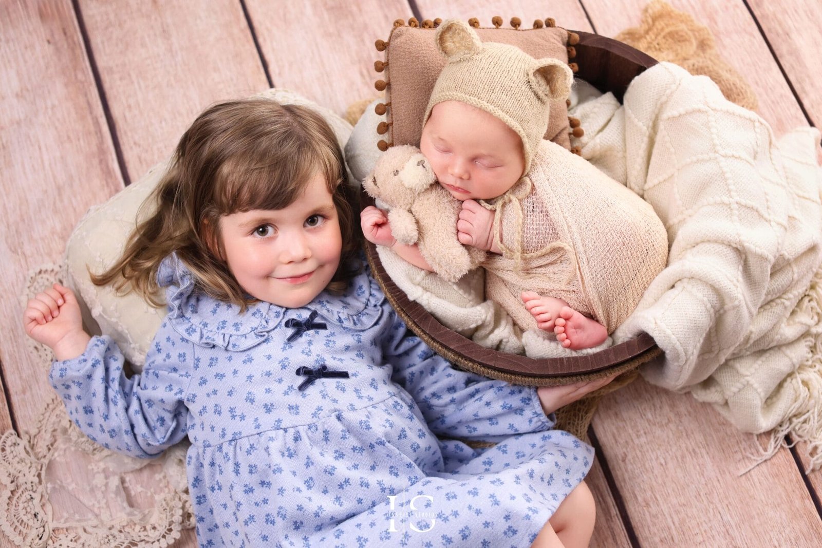 Baby boy newborn photoshoot with sister in East London, captured as a sweet sibling studio portrait.