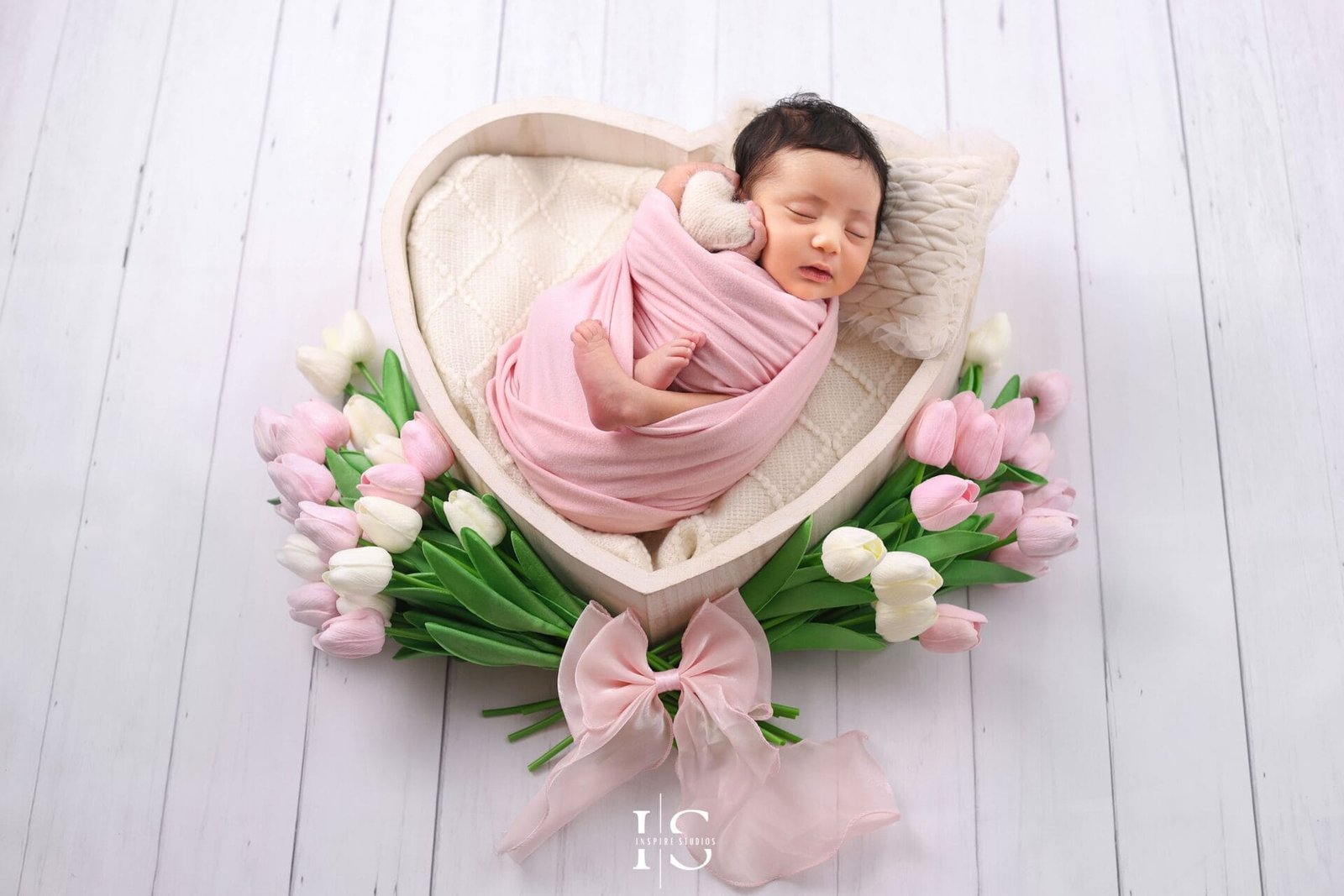Baby girl newborn photoshoot at Inspire Studios London with a heart and tulips photography setup.
