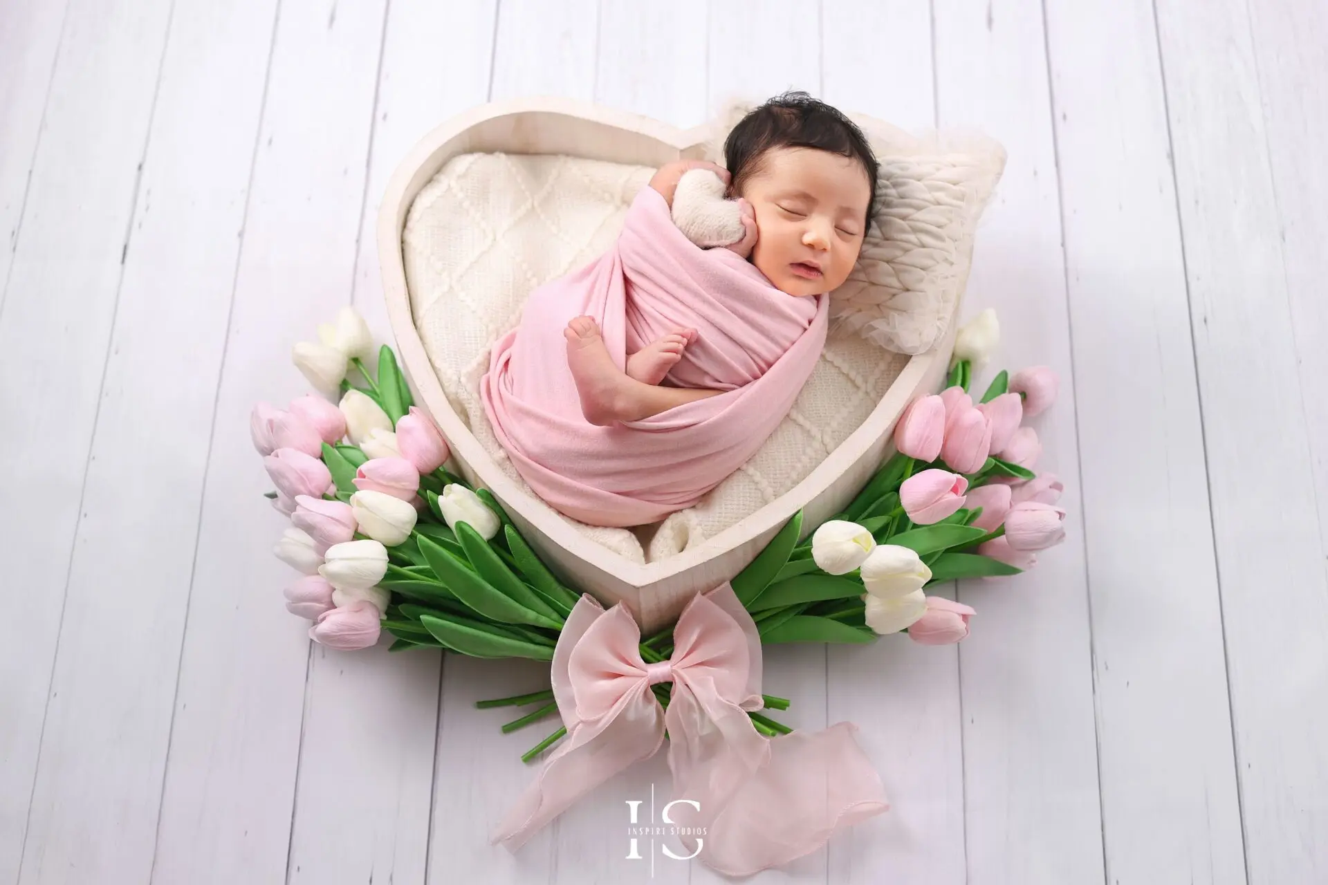 Baby girl newborn photoshoot at Inspire Studios London with a heart and tulips photography setup.