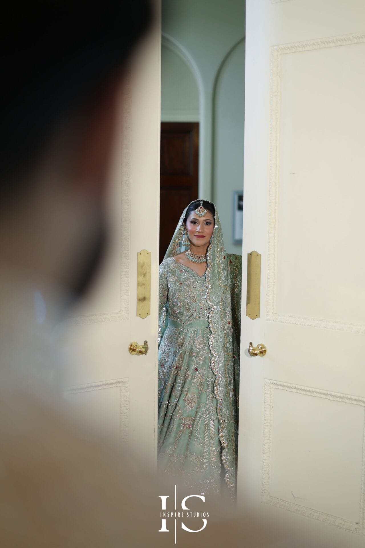Bride and groom posing together for wedding photographs at Hylands House.