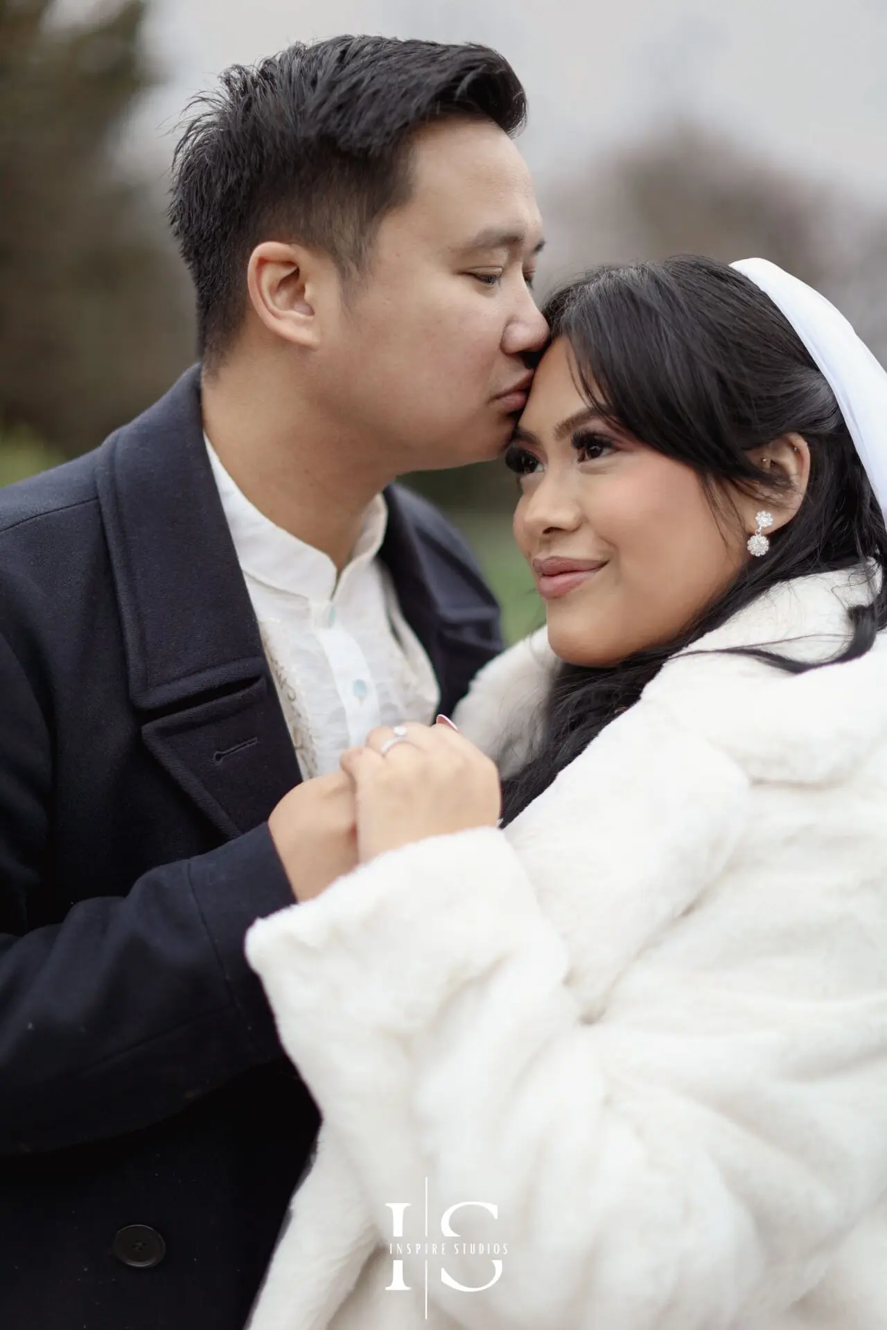Filipino newlywed couple posing for outdoor wedding portraits in Danson Park, Bexley.