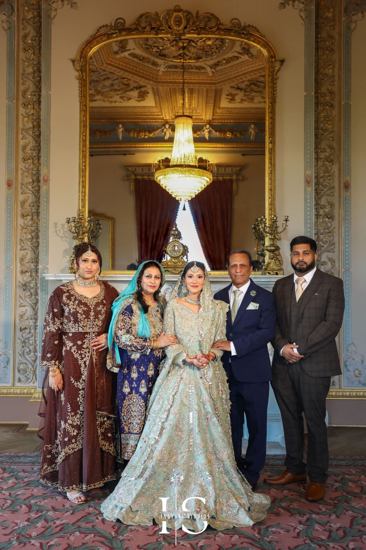 Wedding guests posing for a family photograph inside Hylands House.