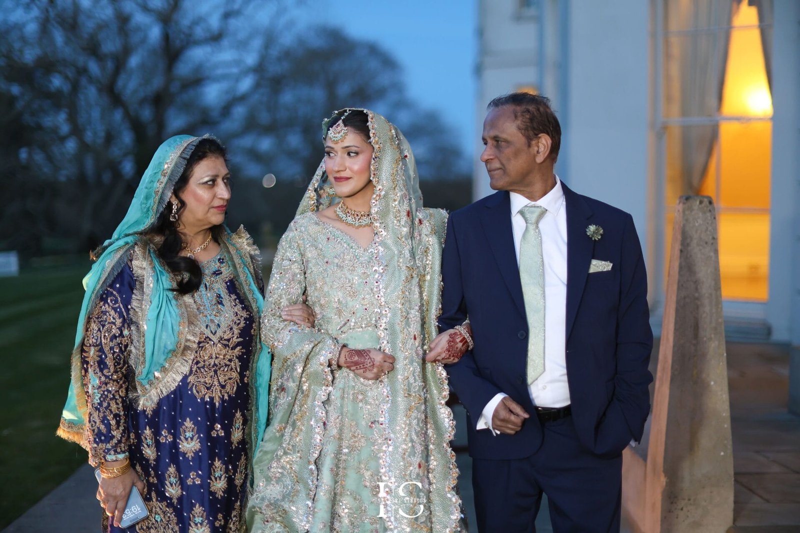 Family posing together for a wedding portrait at Hylands House, Chelmsford.
