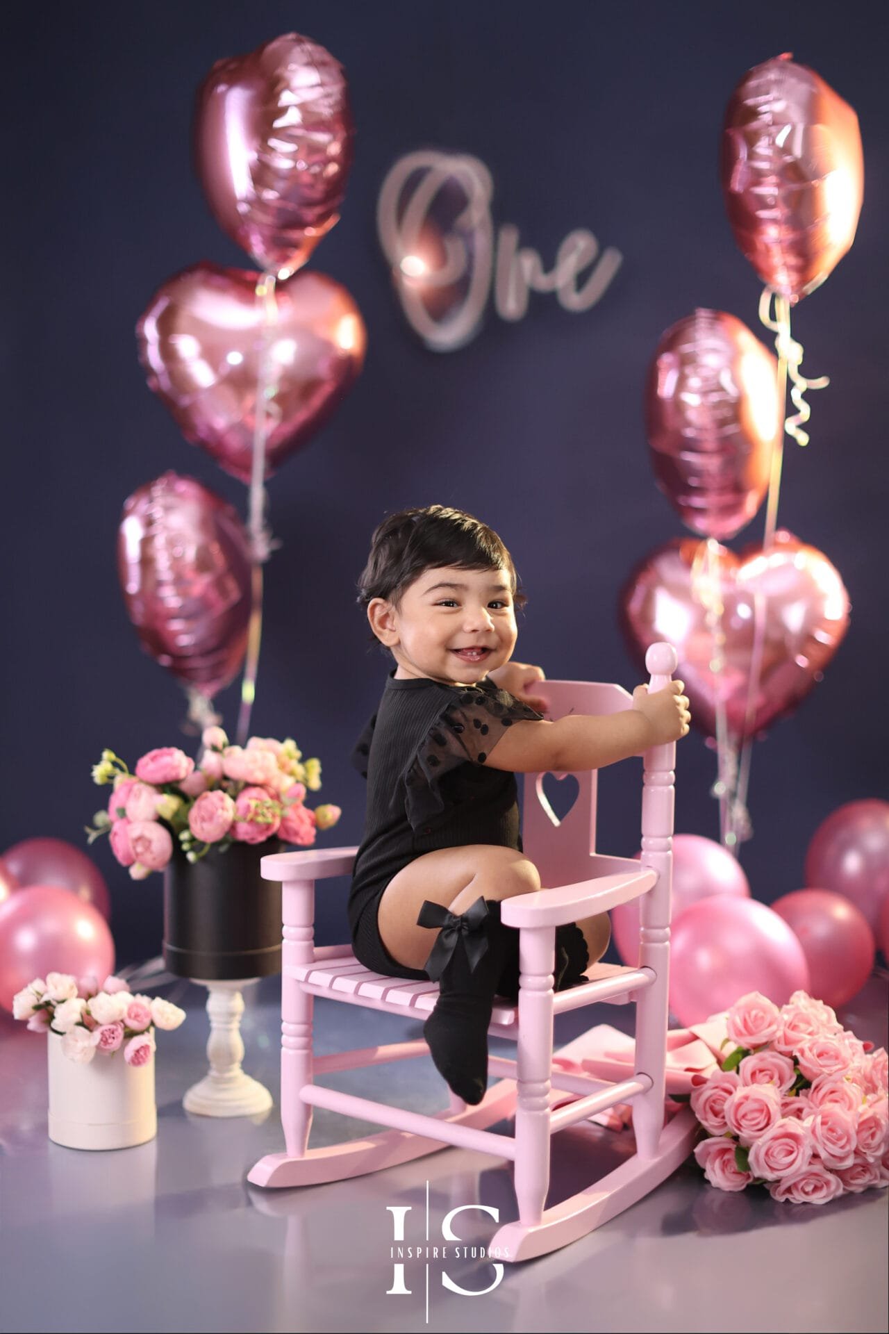 First birthday photoshoot in London for a baby girl with a beautiful studio birthday setup.