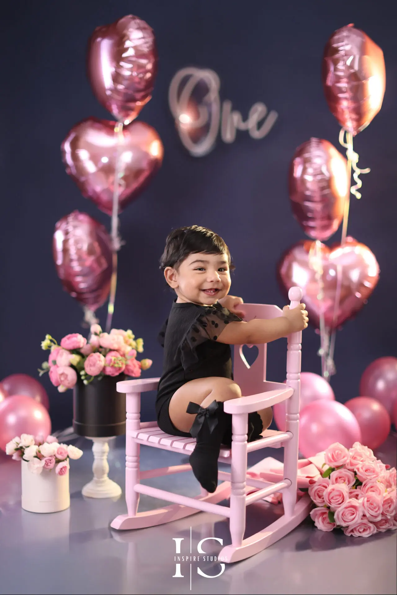 First birthday photoshoot in London for a baby girl with a beautiful studio birthday setup.