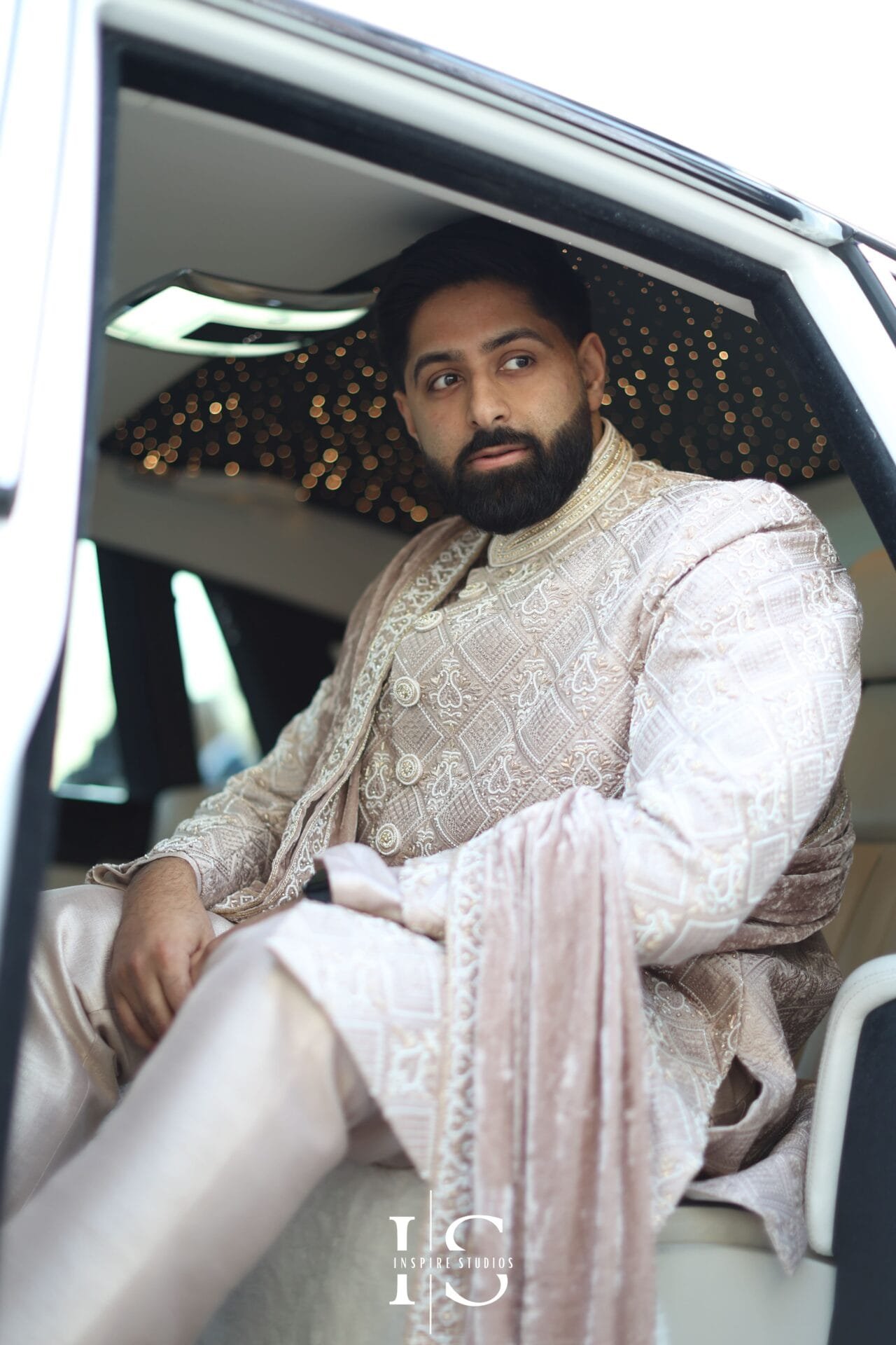 Groom posing for an individual wedding portrait at Hylands House.