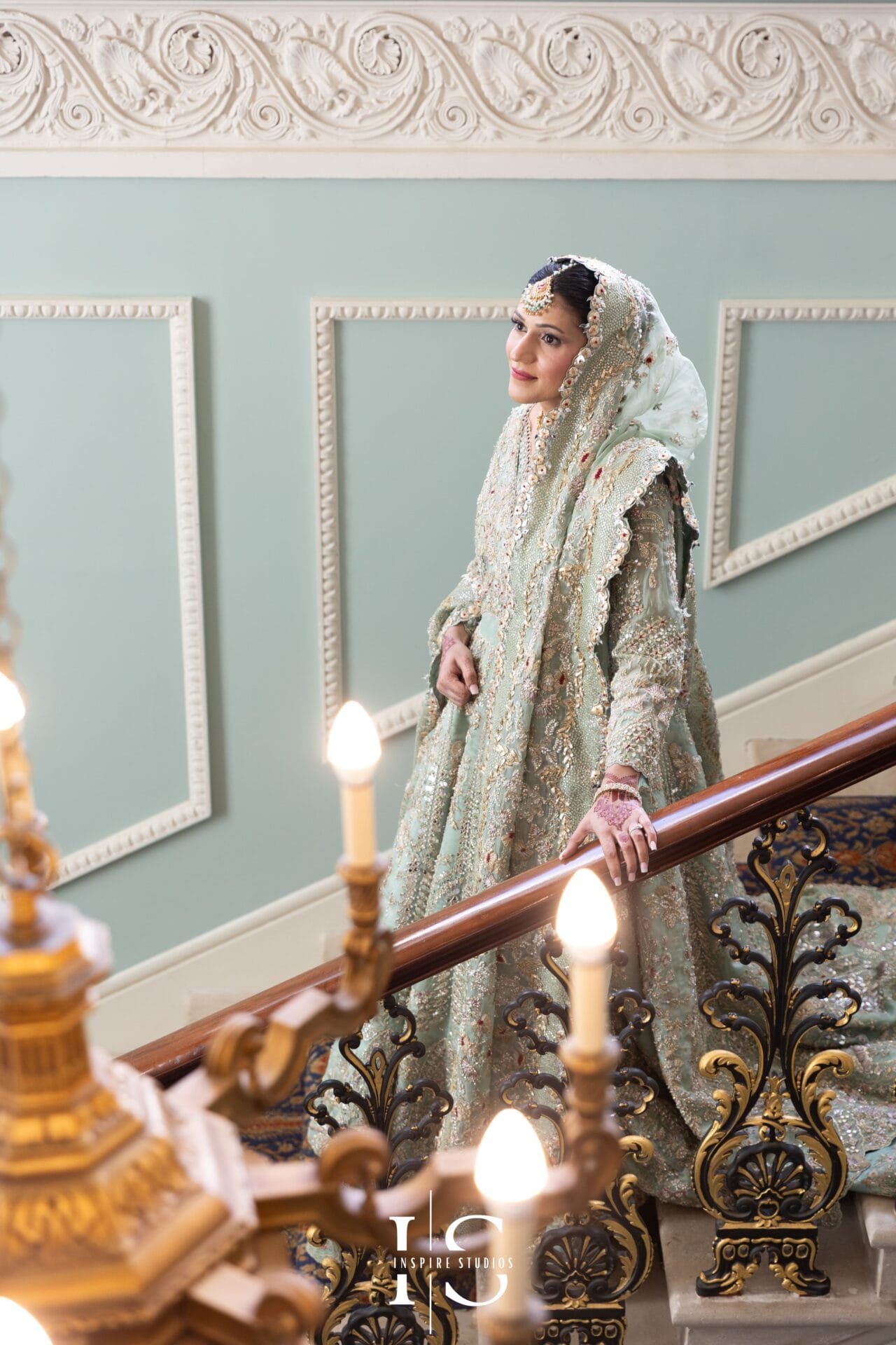 Bride posing for wedding photographs on the Grand Staircase at Hylands House in Chelmsford.