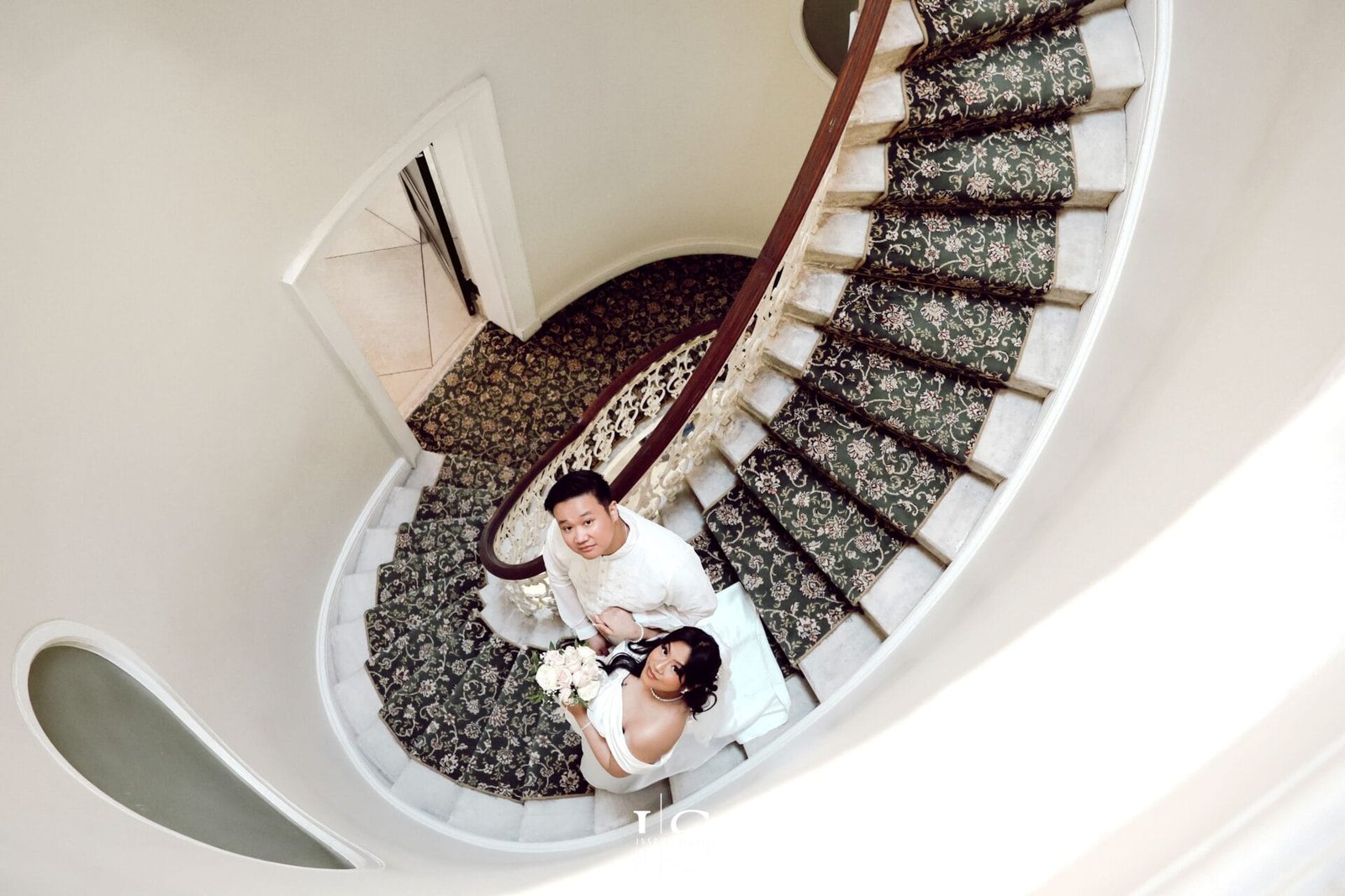 Filipino newlywed couple photographed at the staircase of Danson House by a female photographer from Inspire Studios.