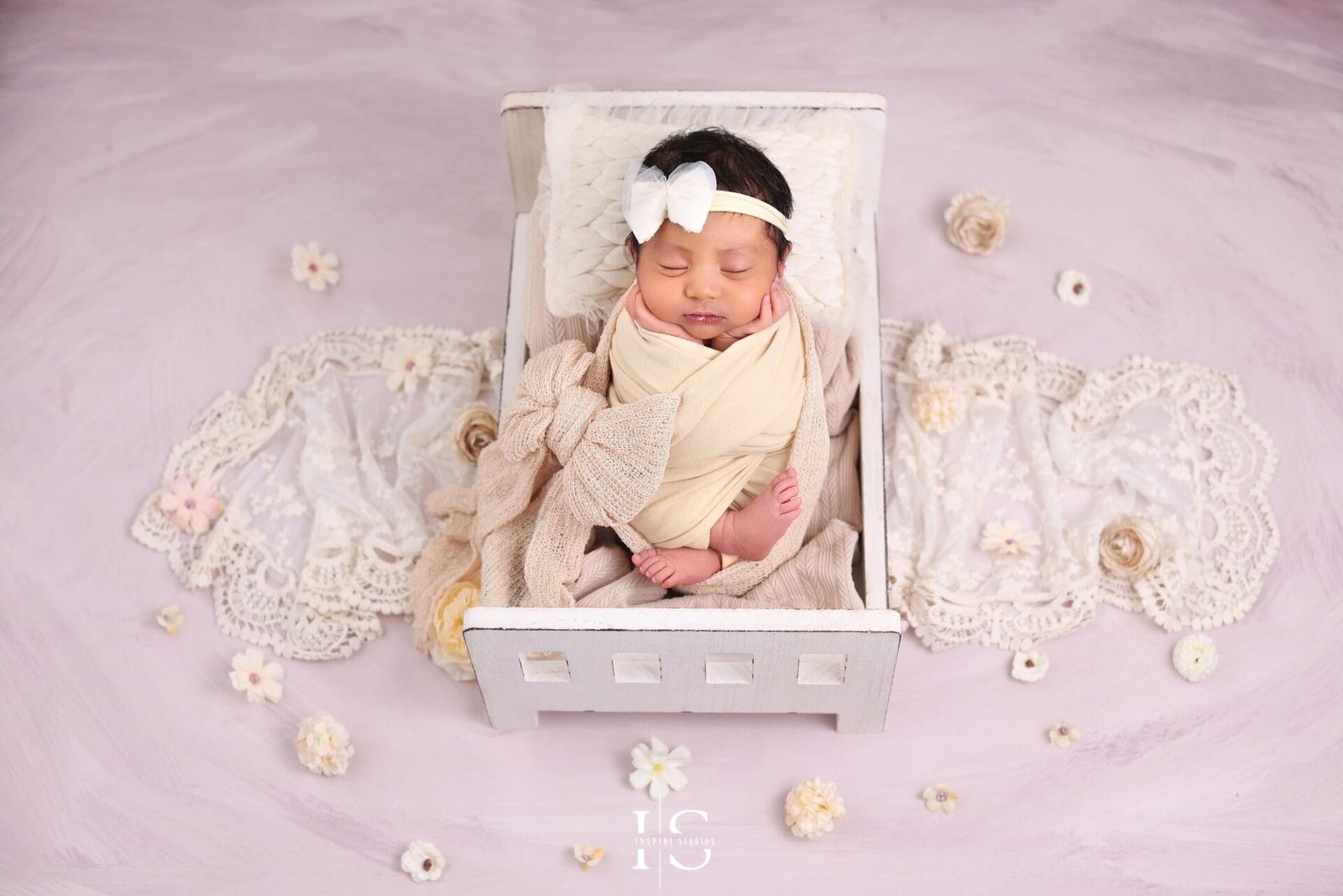 Newborn photoshoot for girls in Walthamstow London with a baby girl posed in a soft studio setup.