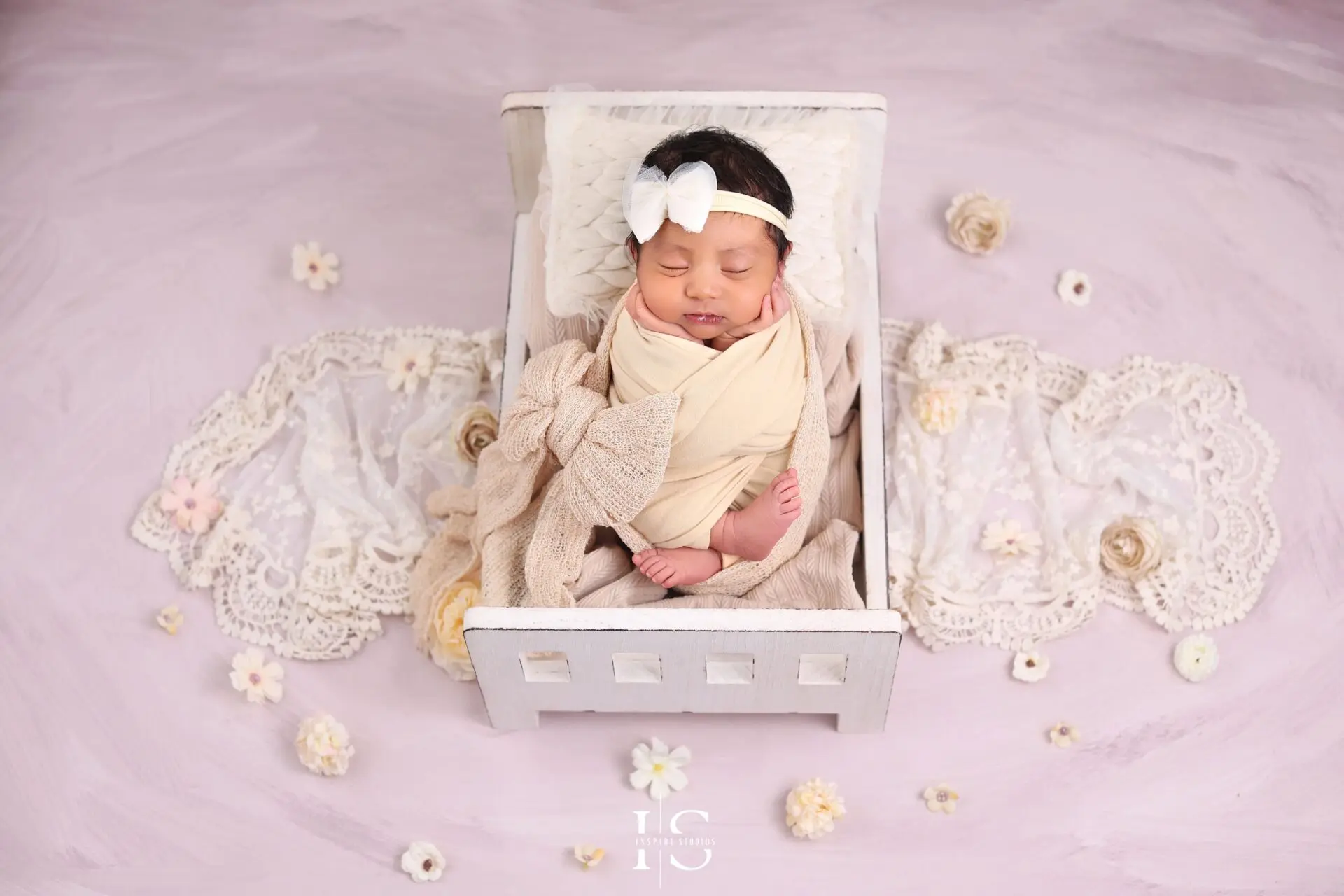Newborn photoshoot for girls in Walthamstow London with a baby girl posed in a soft studio setup.