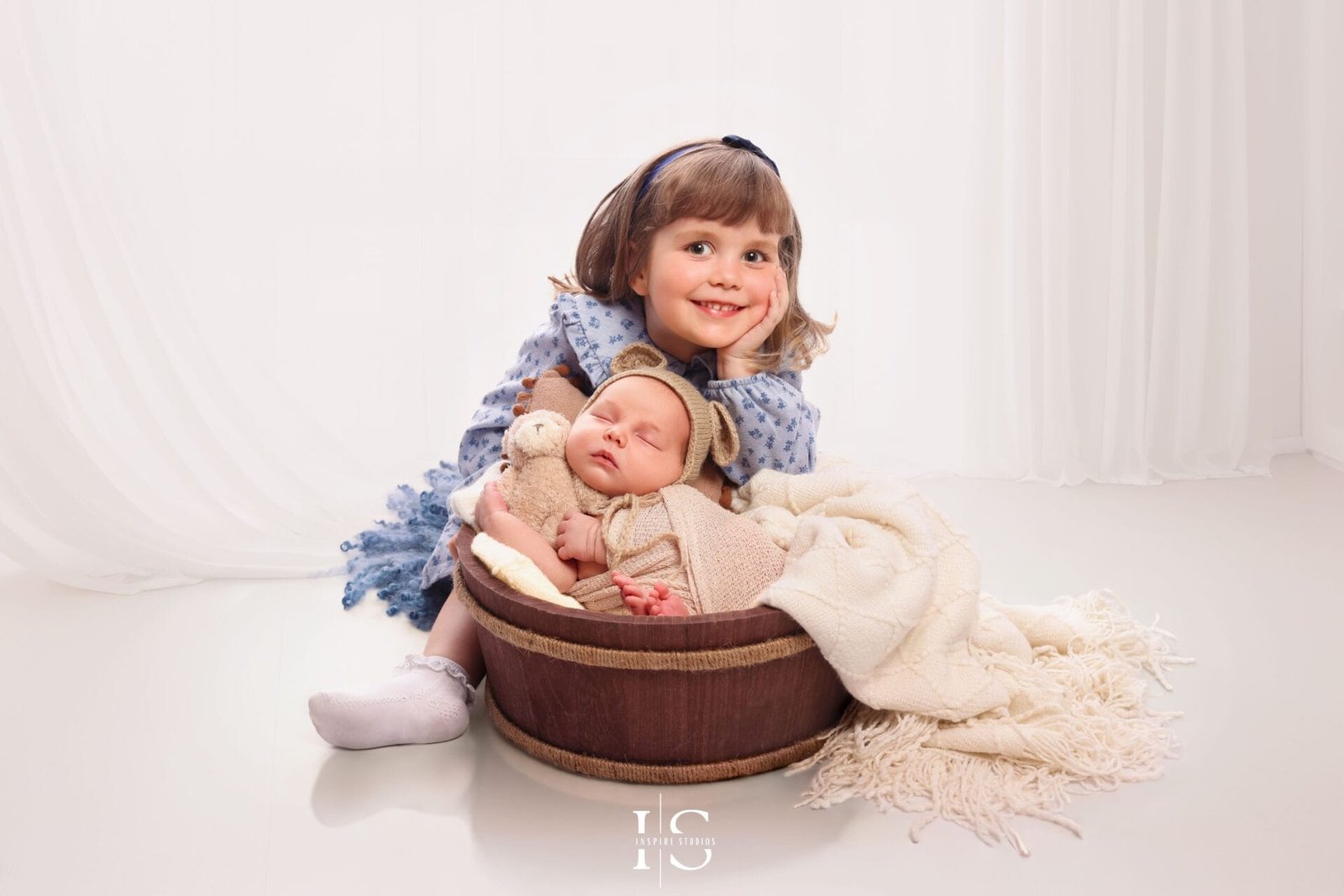 Newborn photoshoot with parents and sibling in Walthamstow London, captured in a professional studio setting.